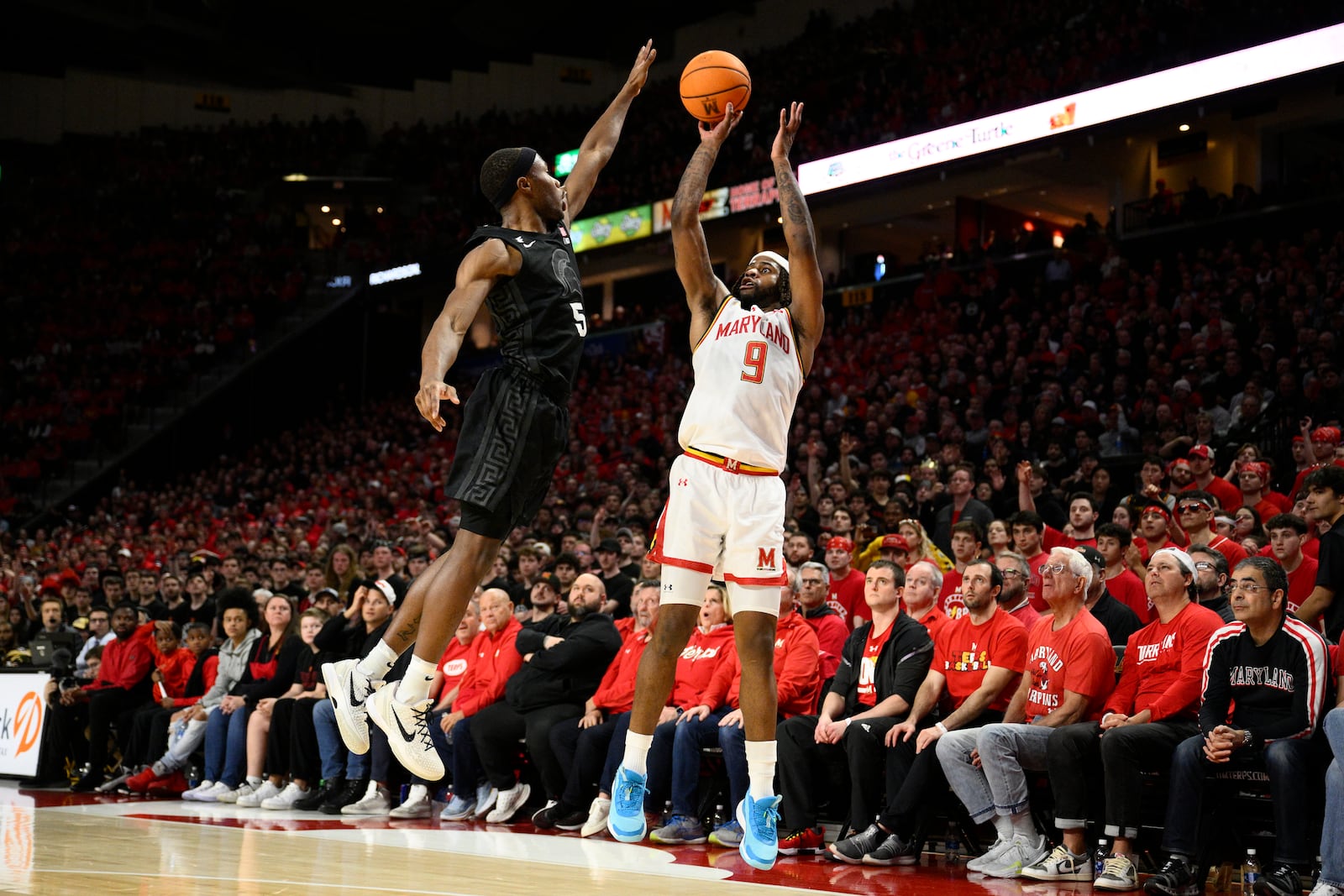 Maryland guard Selton Miguel (9) shoots against Michigan State guard Tre Holloman (5) during the second half of an NCAA college basketball game, Wednesday, Feb. 26, 2025, in College Park, Md. (AP Photo/Nick Wass)