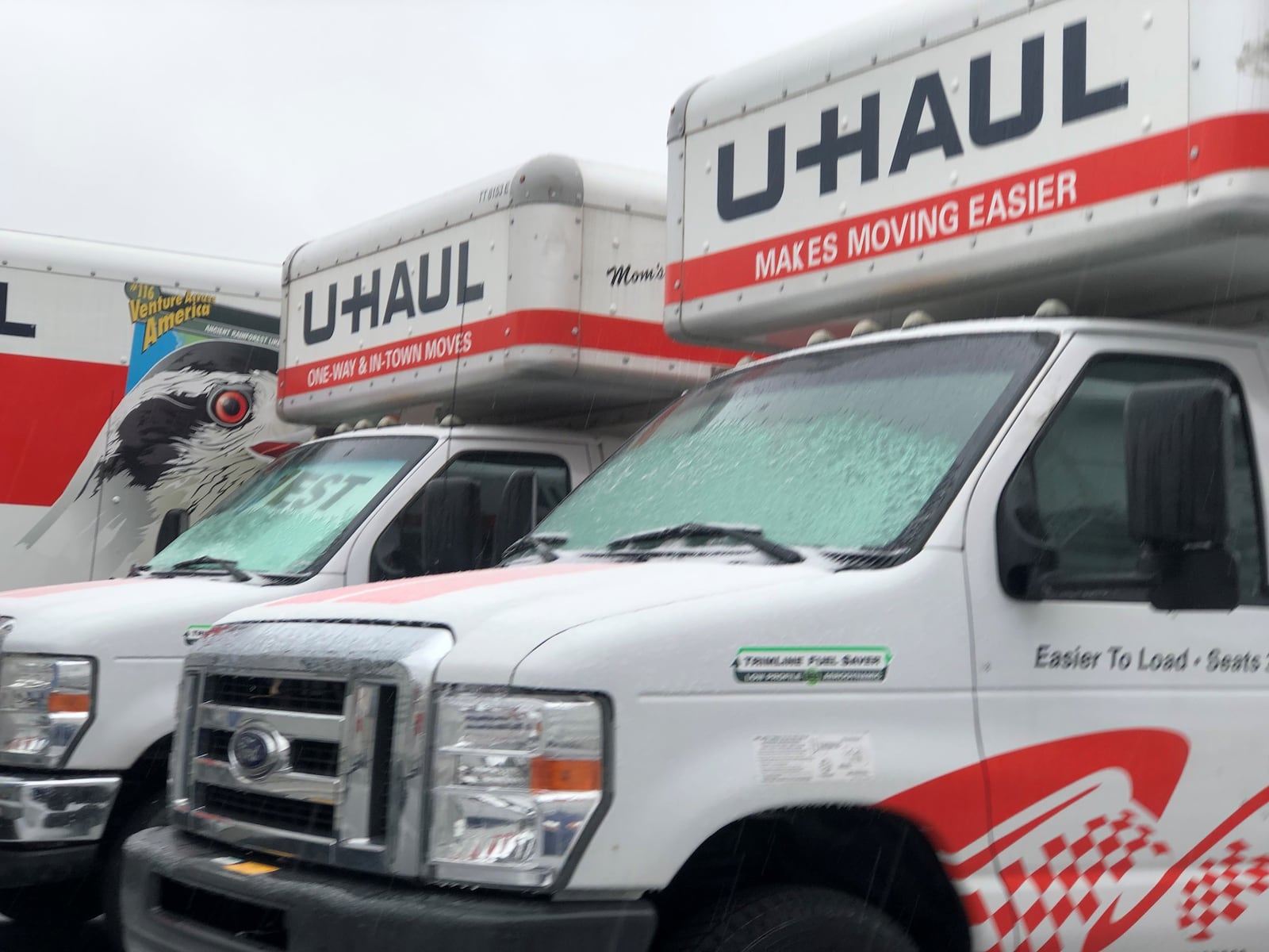 U-Haul moving trucks parked on a lot on East Third Street in Dayton. CORNELIUS FROLIK / STAFF