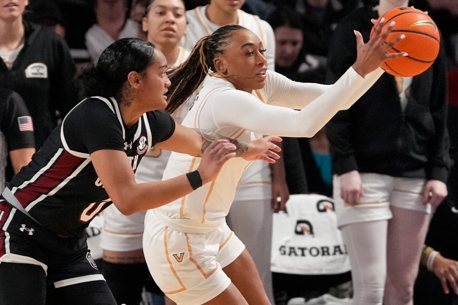 Vanderbilt guard Mikayla Blakes, right, passes the ball away from South Carolina guard Te-Hina Paopao, left, during the second half of an NCAA college basketball game Sunday, Feb. 23, 2025, in Nashville, Tenn. (AP Photo/George Walker IV)