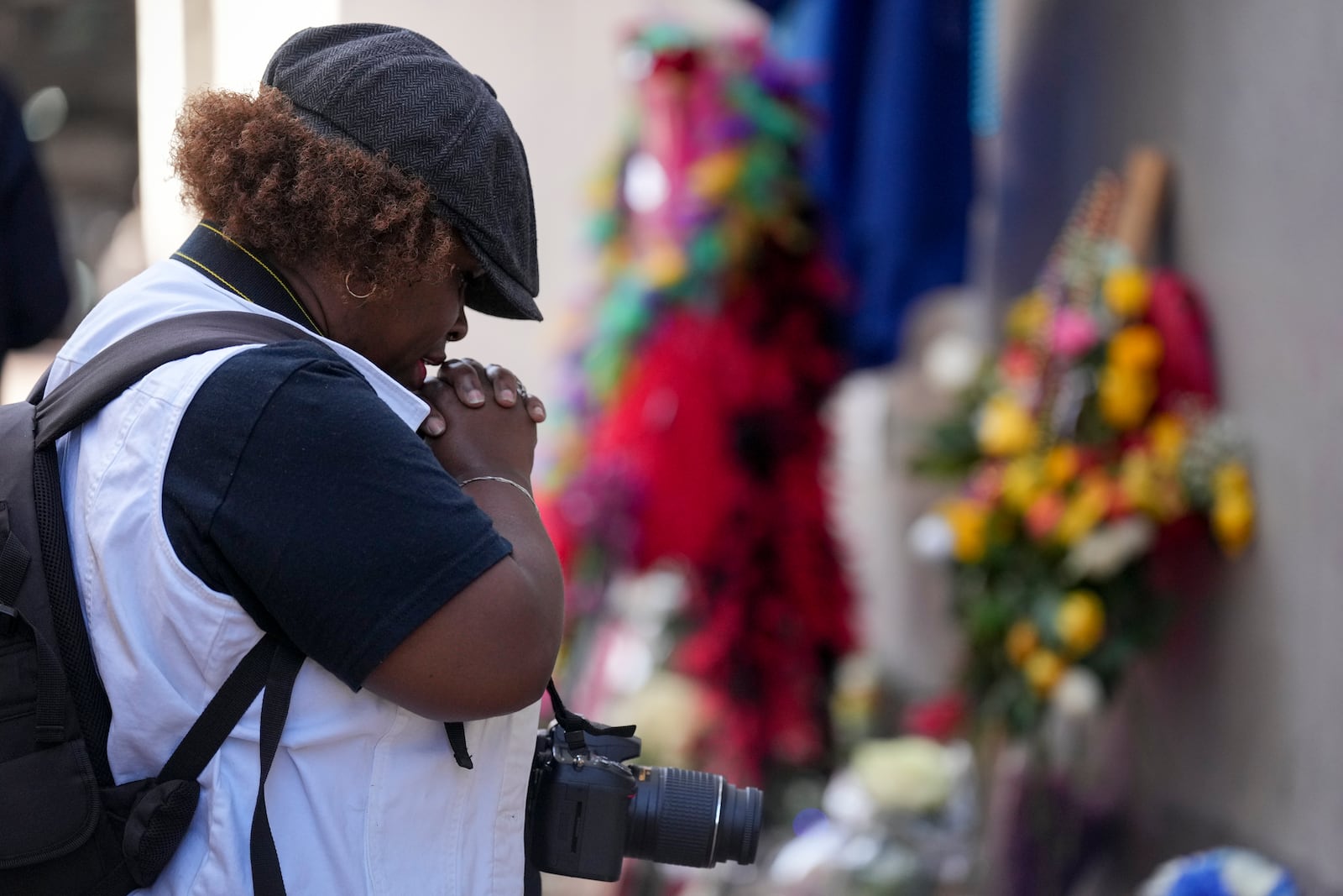 Shawn Westbrook prays at a memorial to the victims of a deadly truck attack on Bourbon Street in the French Quarter, Friday, Jan. 3, 2025, in New Orleans. (AP Photo/George Walker IV)