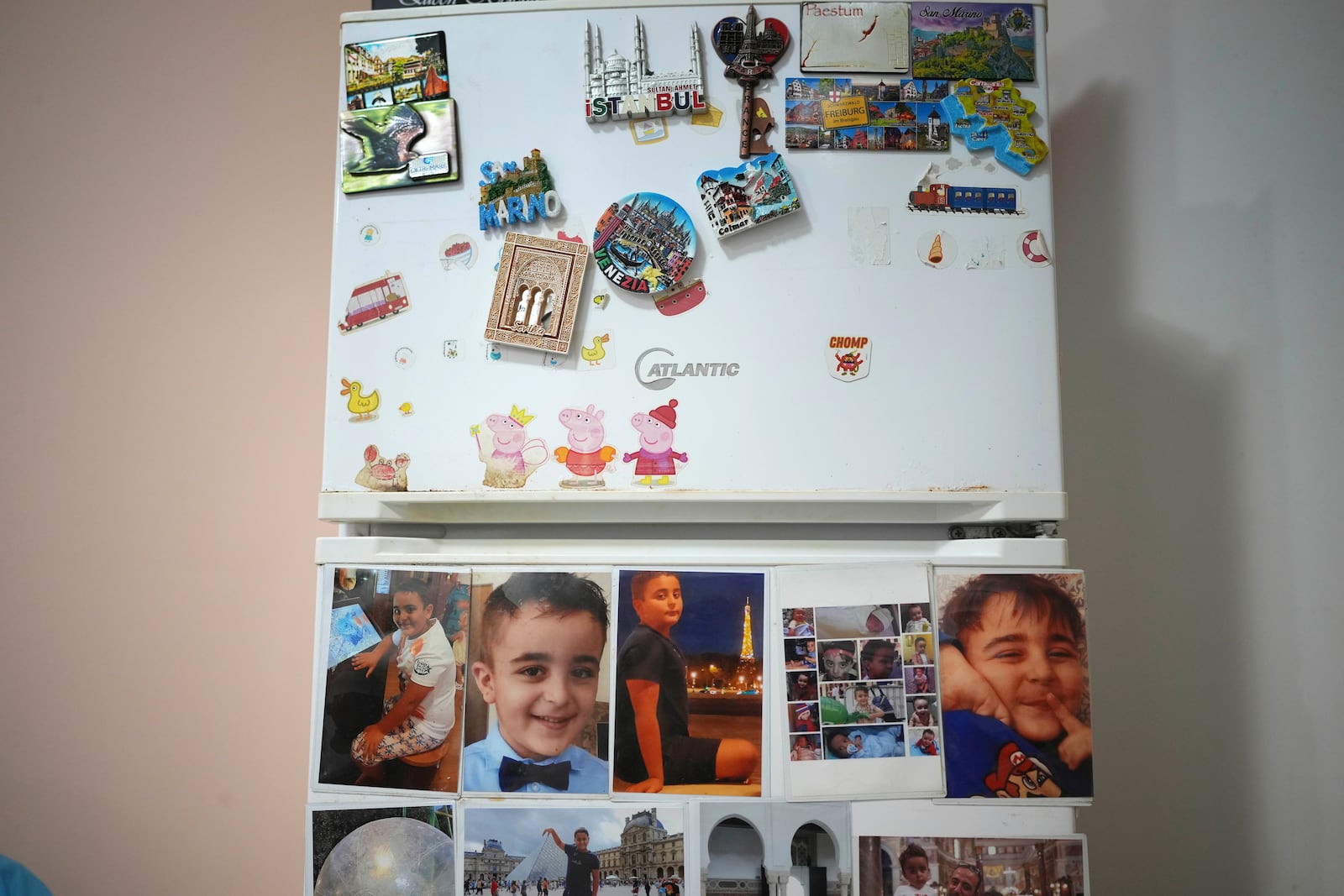 Photos of Riad Zaheda, son of Hasan Zaheda and Nour Essa are stick on their fridge in their house in Rome, Sunday, March 2, 2025. (AP Photo/Alessandra Tarantino)