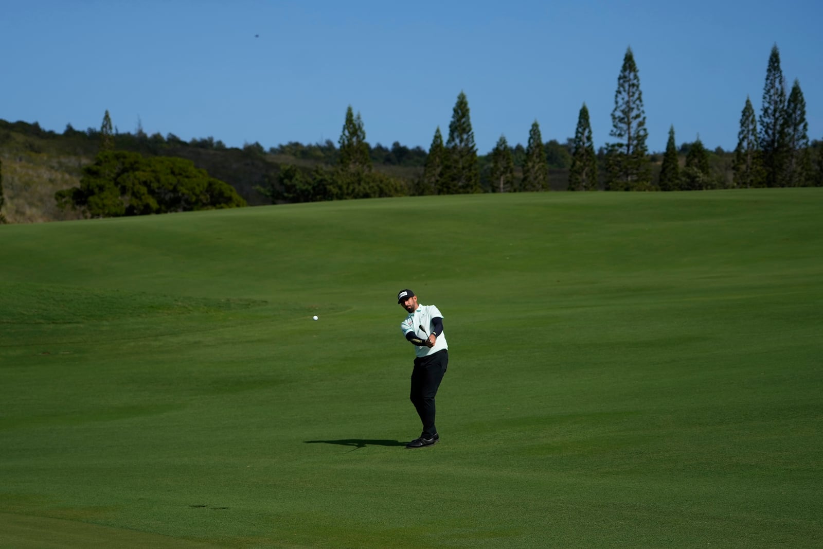 Matthieu Pavon, of France, hits from the 12th fairway during the first round of The Sentry golf event, Thursday, Jan. 2, 2025, at Kapalua Plantation Course in Kapalua, Hawaii. (AP Photo/Matt York)