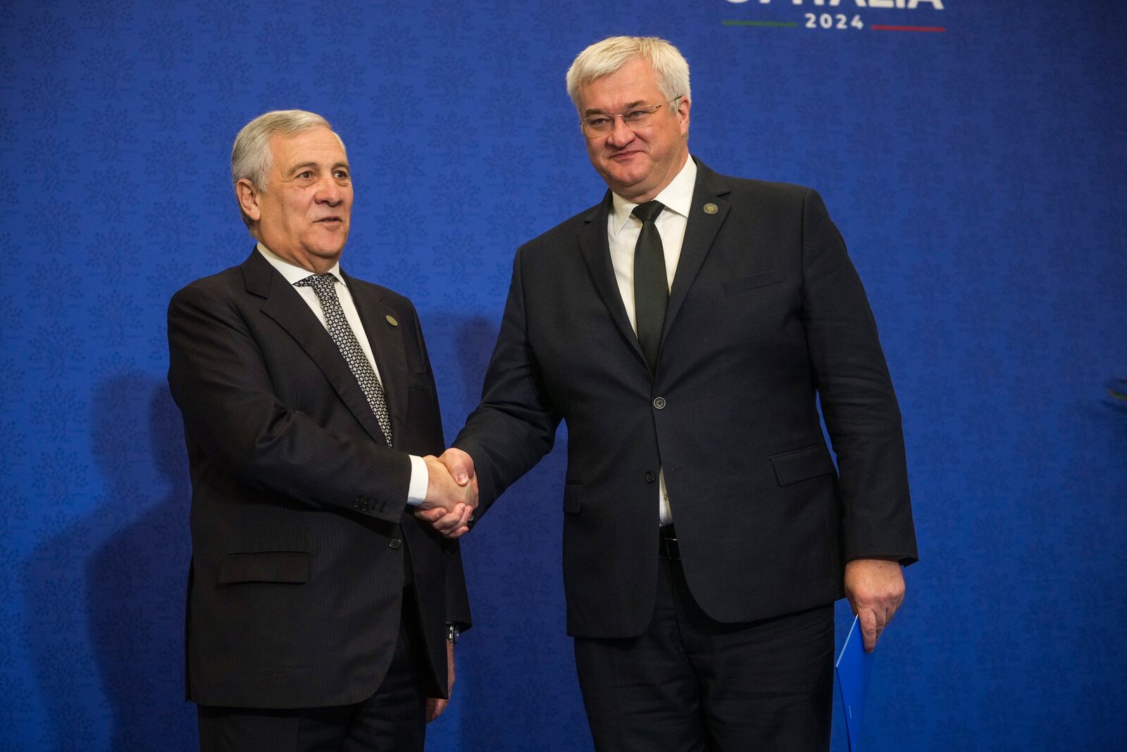 Italian Foreign Minister Antonio Tajani, left, welcomes Ukrainian Foreign Minister Andrii Sybiha for a family photo at the G7 of foreign Ministers in Fiuggi, some 70 kilometers south-east of Rome, Tuesday, Nov. 26, 2024. (AP Photo/Alessandra Tarantino, Pool)