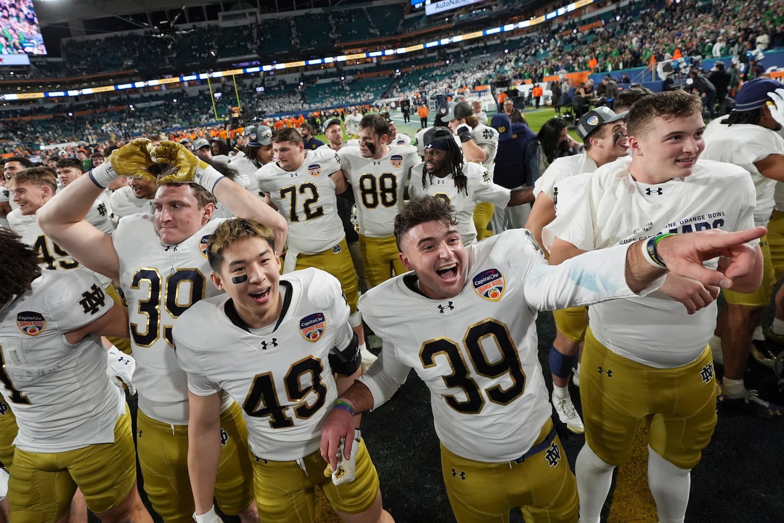 Notre Dame players celebrate after winning the Orange Bowl College Football Playoff semifinal game against Penn State, Thursday, Jan. 9, 2025, in Miami Gardens, Fla. (AP Photo/Rebecca Blackwell)