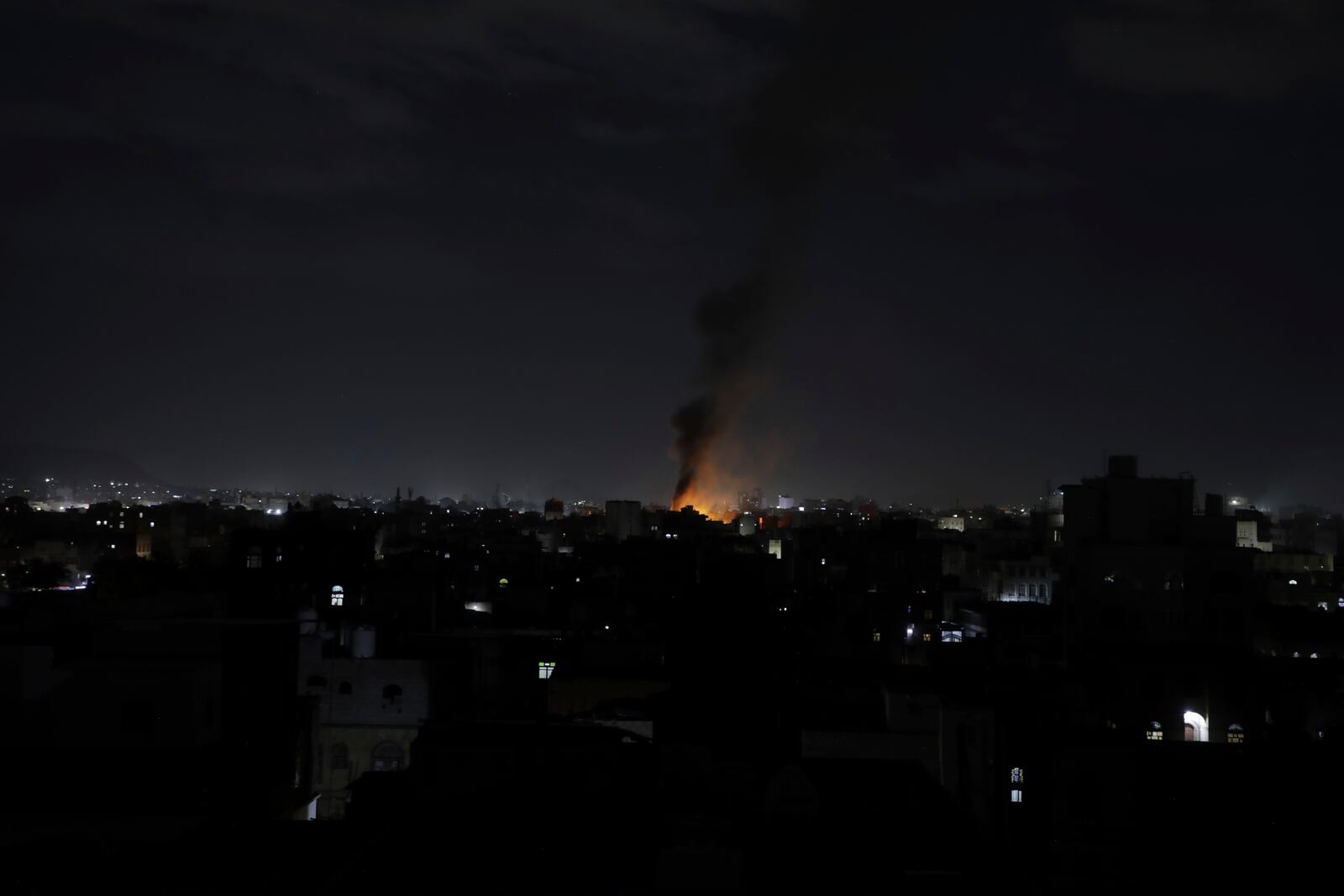 Smoke rises from a location reportedly struck by U.S. airstrikes in Sanaa, Yemen, Wednesday, March 19, 2025. (AP Photo/Osamah Abdulrahman)