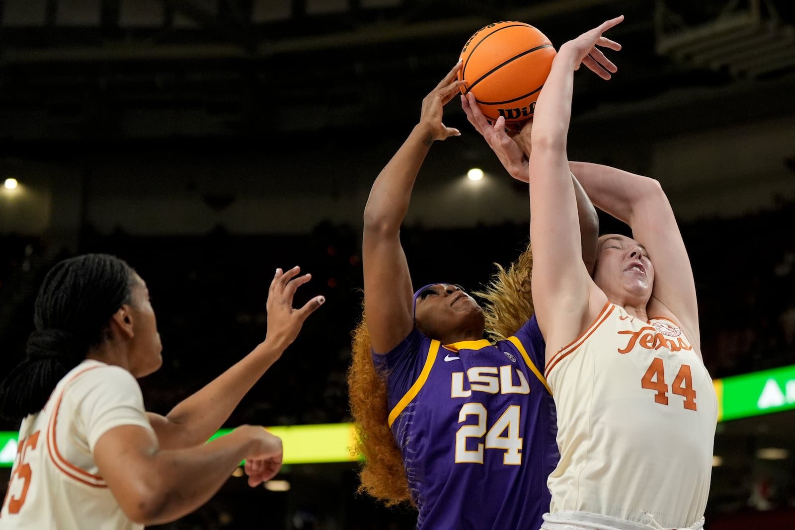 Texas forward Taylor Jones (44) vies for the ball with LSU guard Aneesah Morrow during the first half during of an NCAA college basketball game in the semifinals of the Southeastern Conference tournament, Saturday, March 8, 2025, in Greenville, S.C. (AP Photo/Chris Carlson)