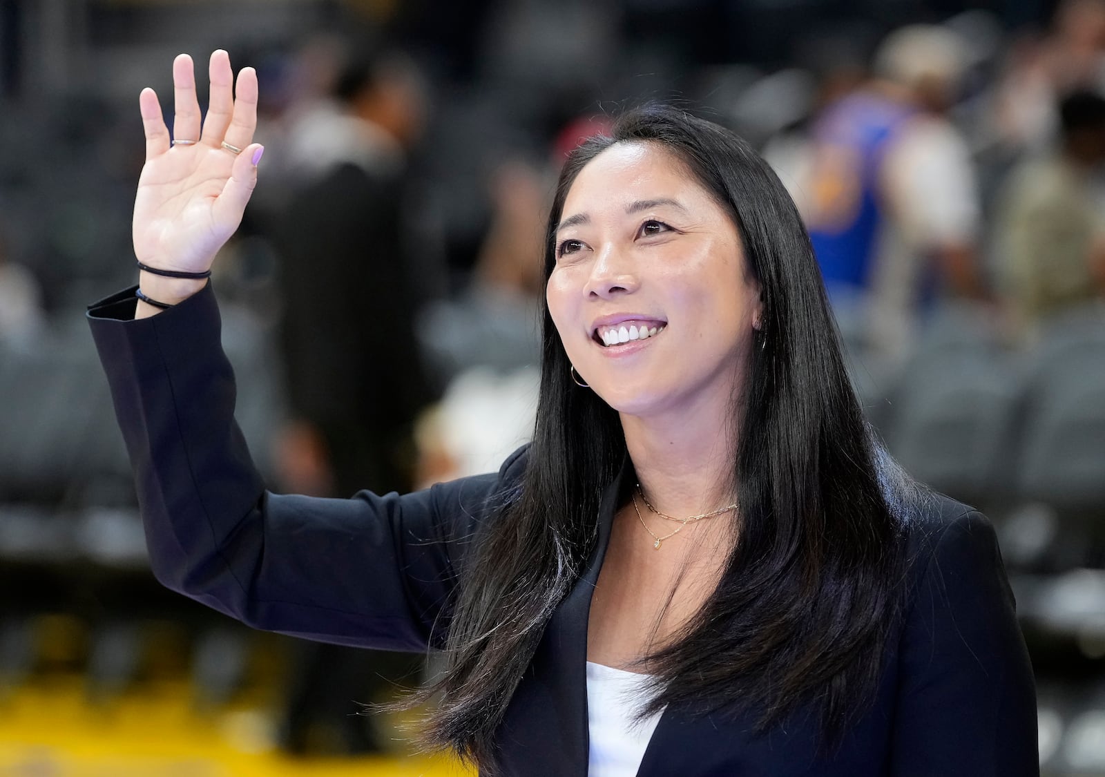 FILE - Golden State Valkyries WNBA head coach Natalie Nakase waves before an NBA preseason basketball game between the Golden State Warriors and the Sacramento Kings in San Francisco, Oct. 11, 2024. (AP Photo/Jeff Chiu, File)