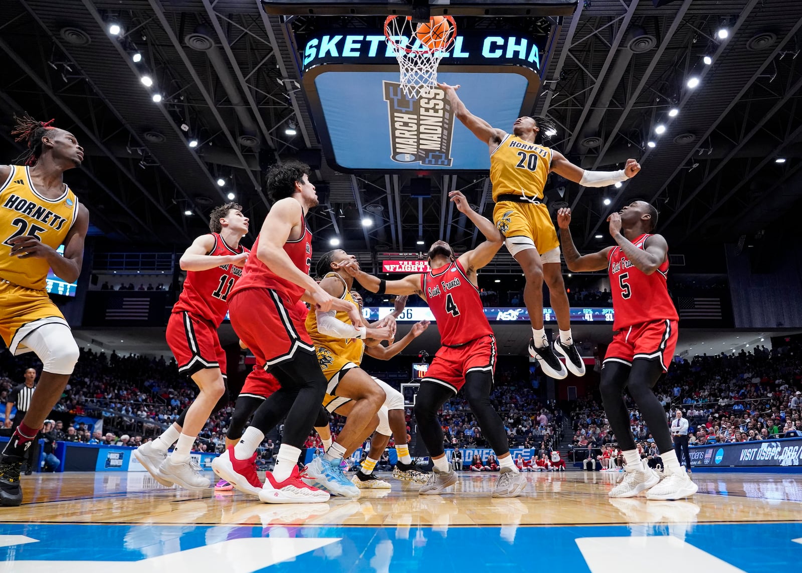 Alabama State guard TJ Madlock (20) shoots against Saint Francis' Daemar Kelly (5) and Juan Cranford Jr. (4) during the second half of a First Four college basketball game in the NCAA Tournament, Tuesday, March 18, 2025, in Dayton, Ohio. (AP Photo/Jeff Dean)