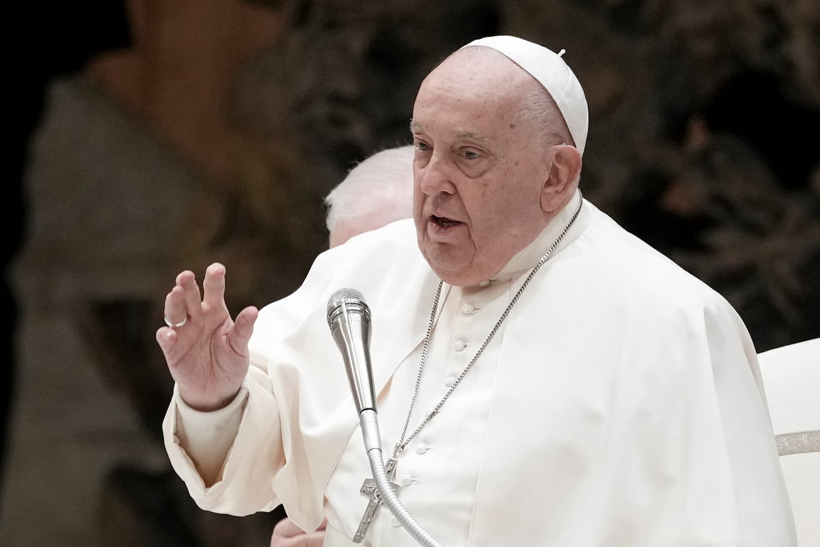 Pope Francis delivers his blessing as he exchanges season greetings with Vatican employees, in the Paul VI Hall at the Vatican, Saturday, Dec. 21, 2024. (AP Photo/Andrew Medichini)