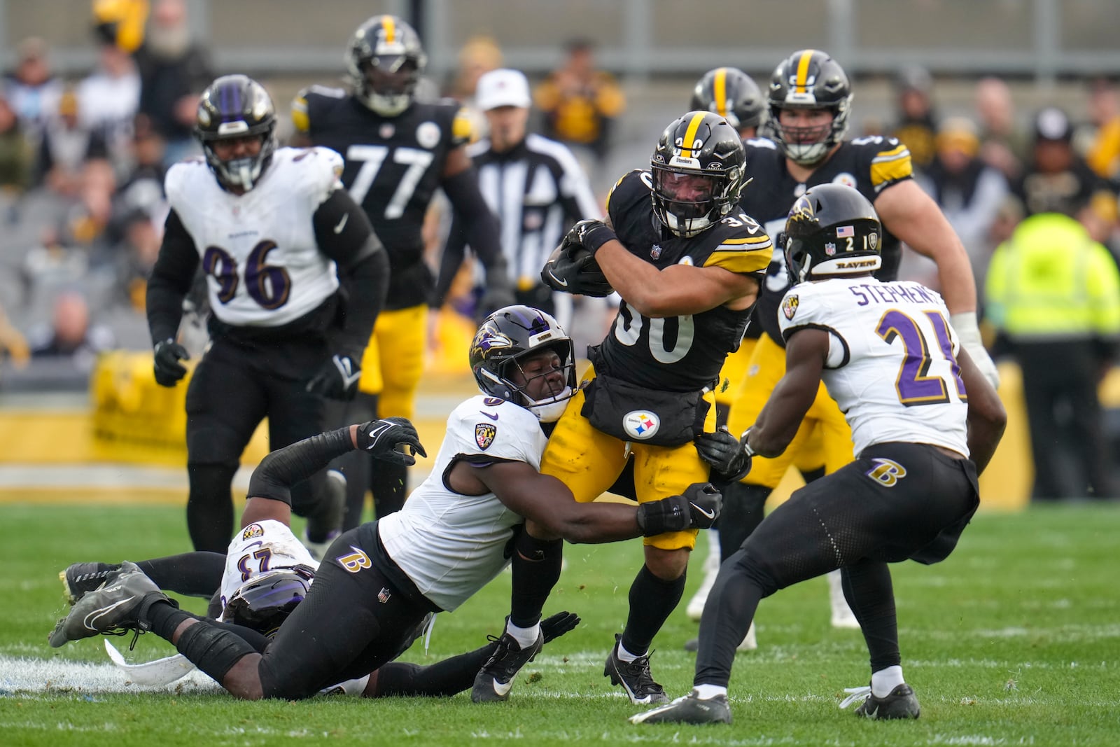 Pittsburgh Steelers running back Jaylen Warren (30) is brought down by Baltimore Ravens linebacker Roquan Smith, left, after making a catch during the second half of an NFL football game, Sunday, Nov. 17, 2024, in Pittsburgh. (AP Photo/Gene J. Puskar)