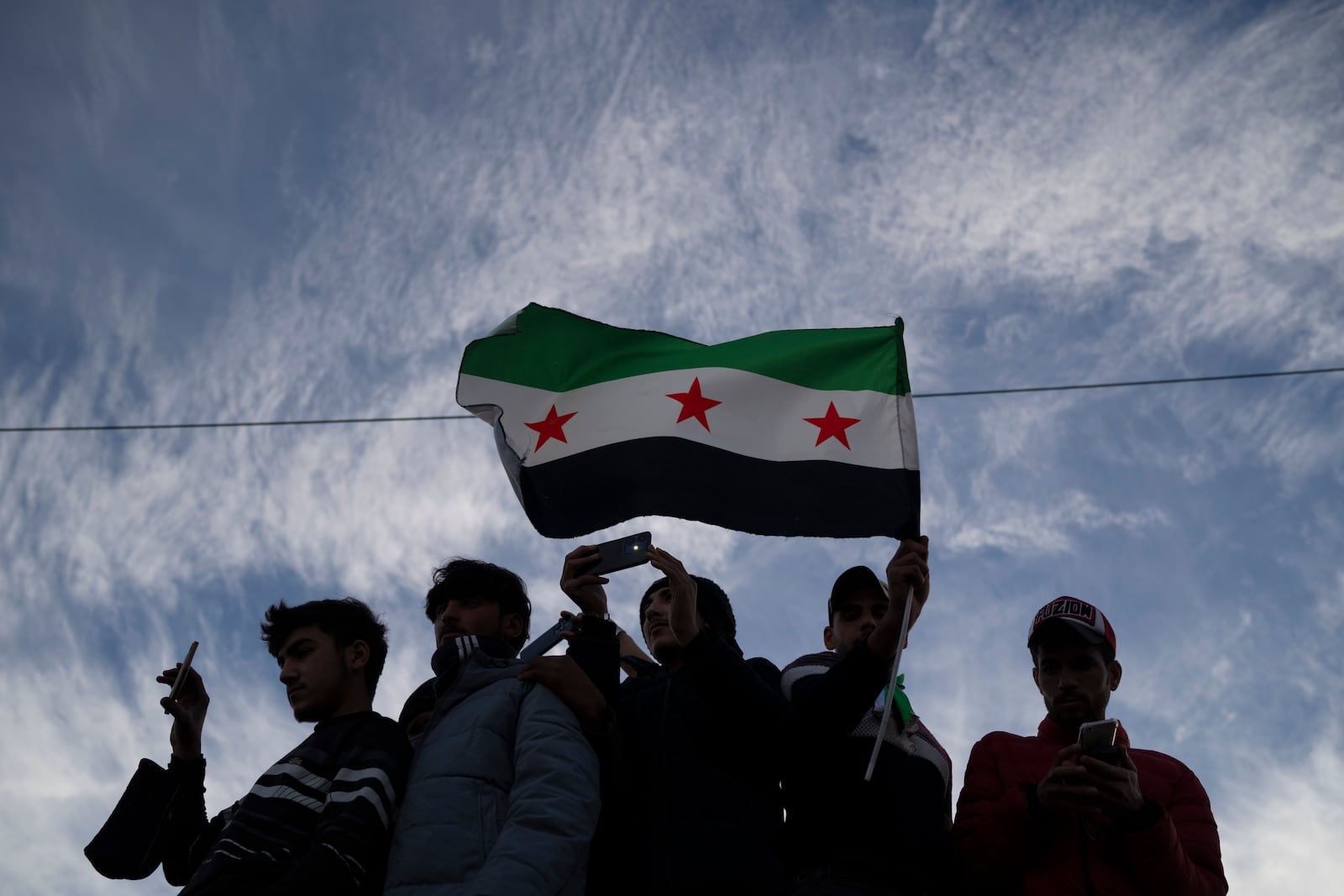 Syrians gather in celebration days after the fall of Bashar Assad's government at the Umayyad Square in Damascus, Thursday, Dec. 12, 2024. (AP Photo/Leo Correa)