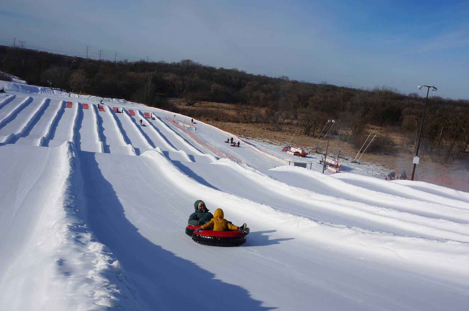 Nasrieen Habib and her four-year-old son go snow tubing during an outing organized by the group Habib founded to promote outdoors activities among Muslim women, at Elm Creek Park Reserve in Maple Grove, Minn., on Jan. 4, 2025. (AP Photo/Giovanna Dell'Orto)