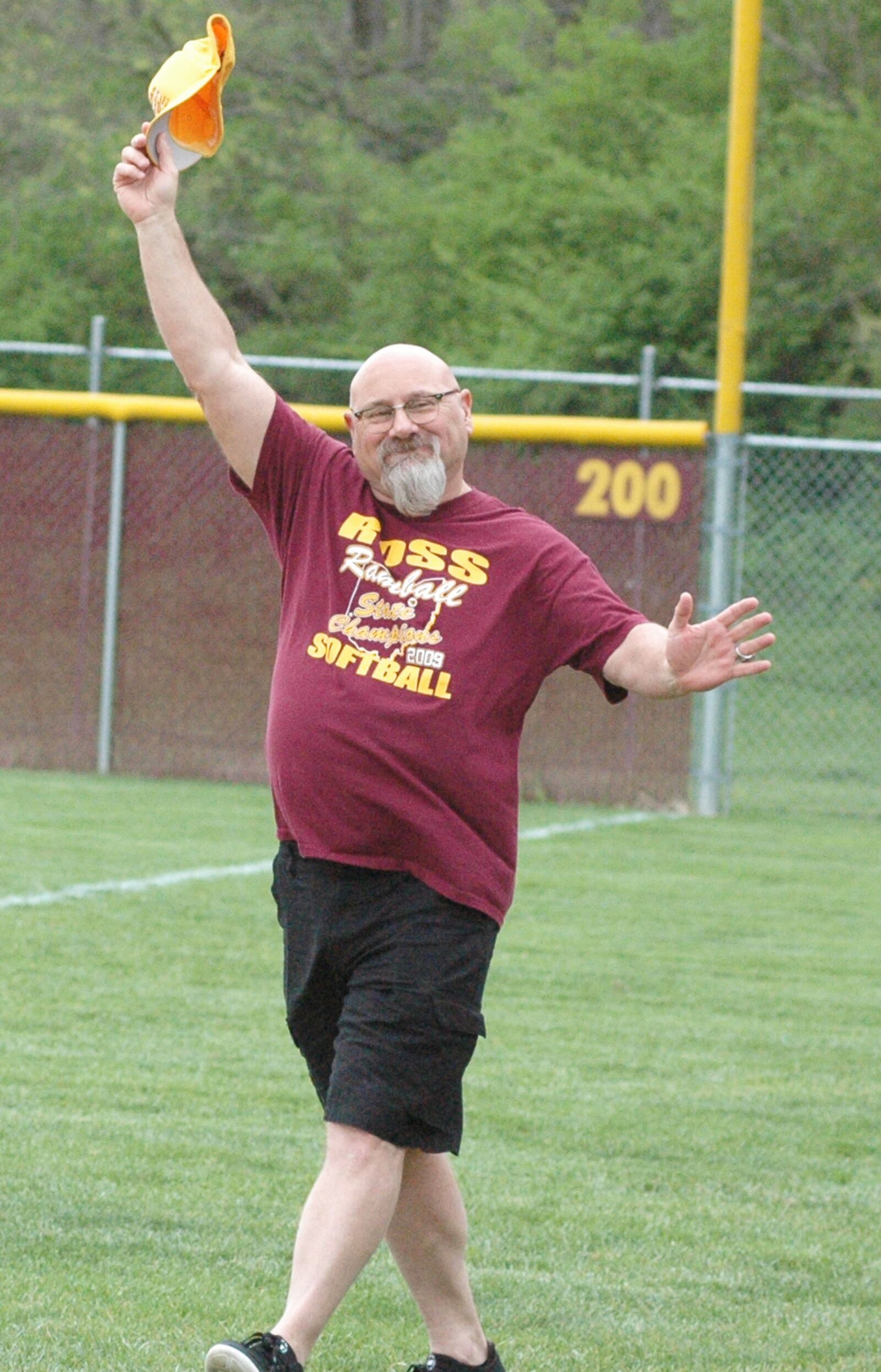 Paul Fernandez, the head coach for Ross High School’s 2009 Division II state championship softball team, waves to the crowd during a ceremony before Wednesday’s game against visiting Northwest. RICK CASSANO/STAFF