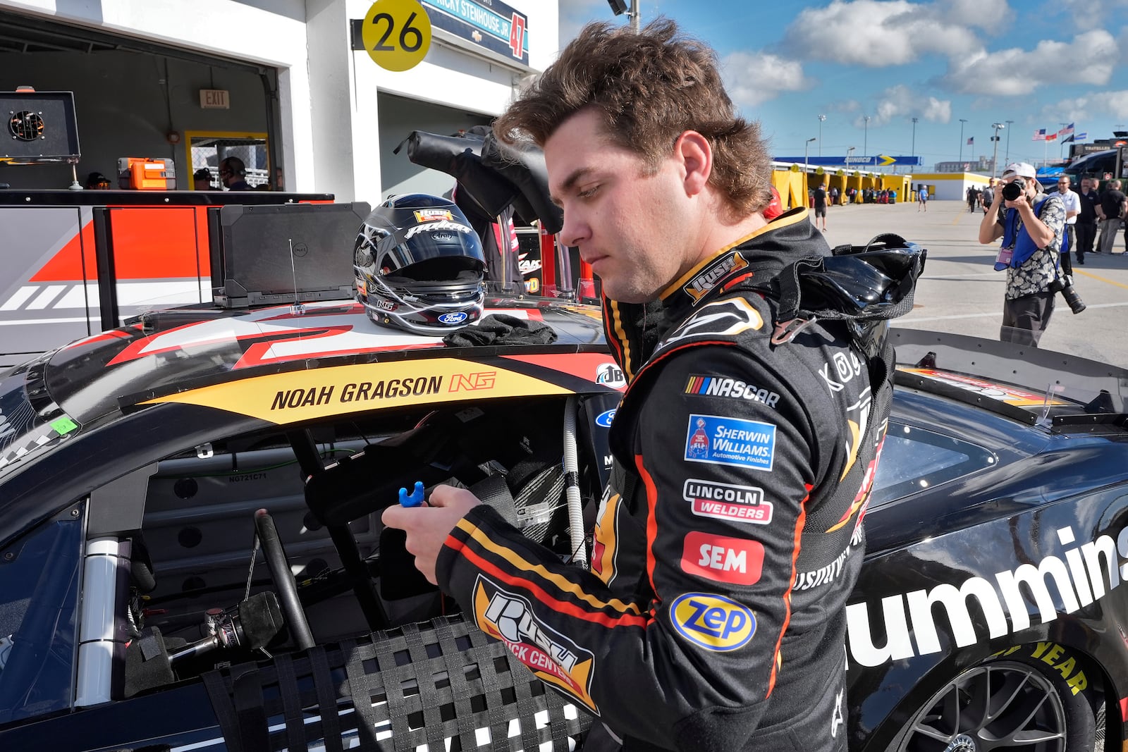 Noah Gragson puts in his ear plugs as he gets ready for practice at the NASACAR Daytona 500 auto race Wednesday, Feb. 12, 2025, at Daytona International Speedway in Daytona Beach, Fla. (AP Photo/Chris O'Meara)