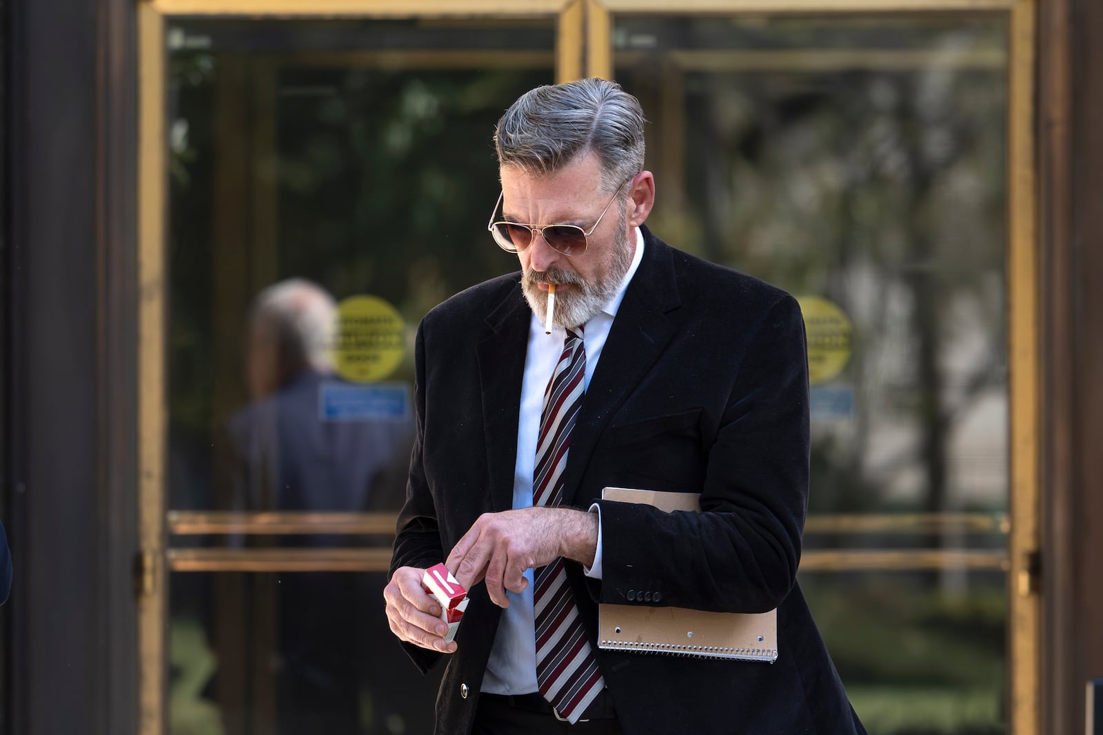 Actor Jay Johnston emerges from the U.S. District Courthouse in Washington, Monday, Oct. 28, 2024, after having been sentenced to one year in prison for his part in a mob’s attack on the U.S. Capitol nearly four years ago. Johnston joined other rioters in a “heave ho” push against police officers guarding a tunnel entrance to the Capitol during the Jan. 6, 2021, riot. (AP Photo/J. Scott Applewhite)