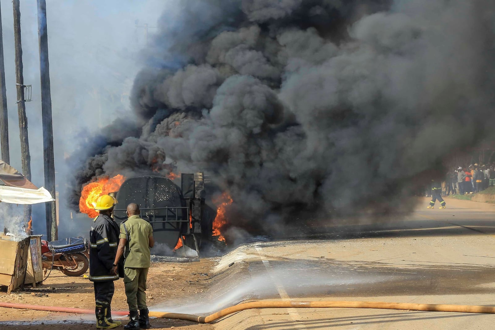 Firefighters try to contain a fire after a fuel truck exploded next to a highway on the outskirts of Kampala, Uganda, Tuesday, Oct. 22, 2024. (AP Photo)