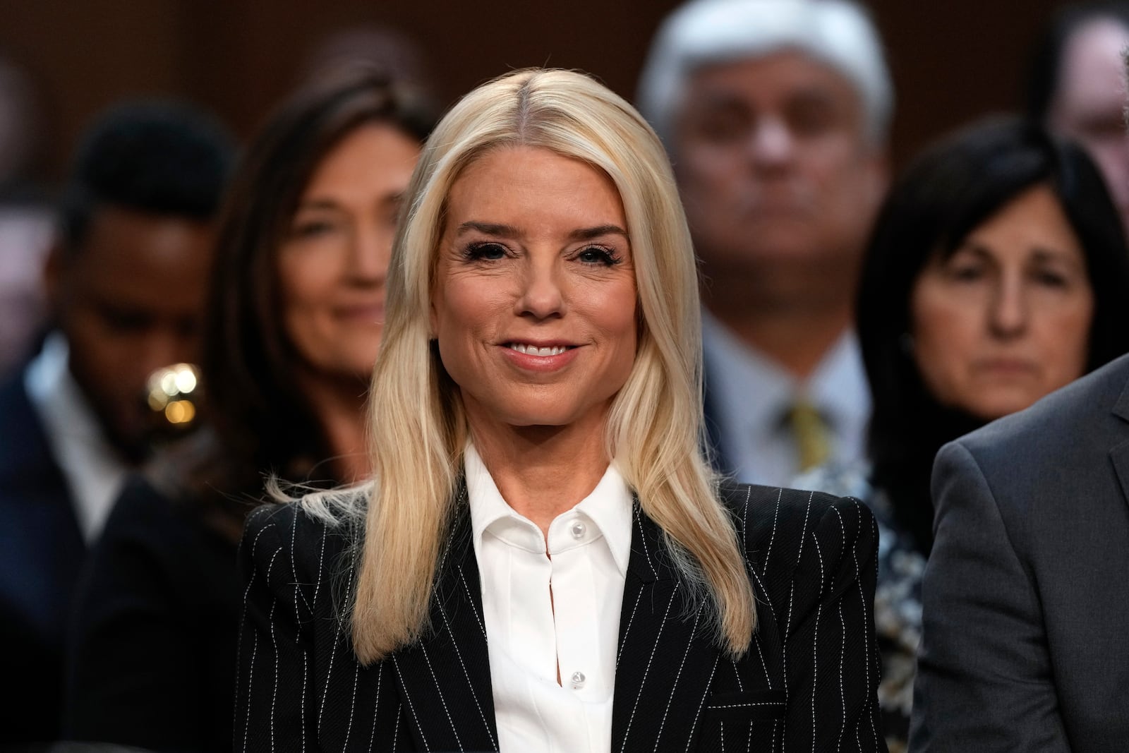 Pam Bondi, President-elect Donald Trump's choice to lead the Justice Department as attorney general, appears before the Senate Judiciary Committee for her confirmation hearing, at the Capitol in Washington, Wednesday, Jan. 15, 2025. (AP Photo/Ben Curtis)