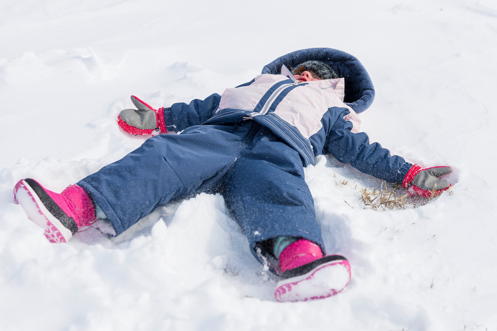 Josie Mueller, 4, makes snow angles at the base of the Holmes Lake hill as a winter storm hits Lincoln, Neb., Wednesday, Feb. 12, 2025. (Kenneth Ferriera/Lincoln Journal Star via AP)