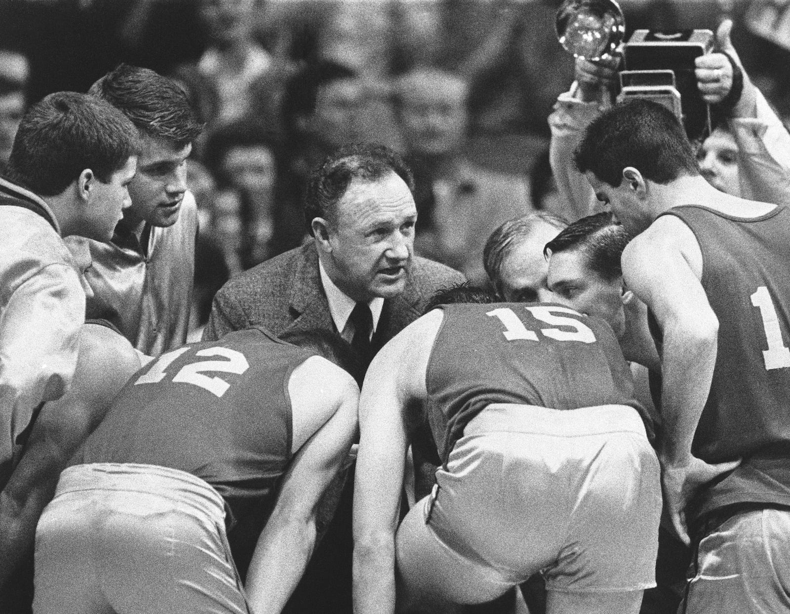 FILE - Actor Gene Hackman gives fictional Hickory High basketball players instructions during filming of the final game of the movie "Hoosiers" at Hinkle Fieldhouse on the Butler University campus, Friday, Dec. 6, 1985 in Indianapolis. (AP Photo/Tom Strickland, File)