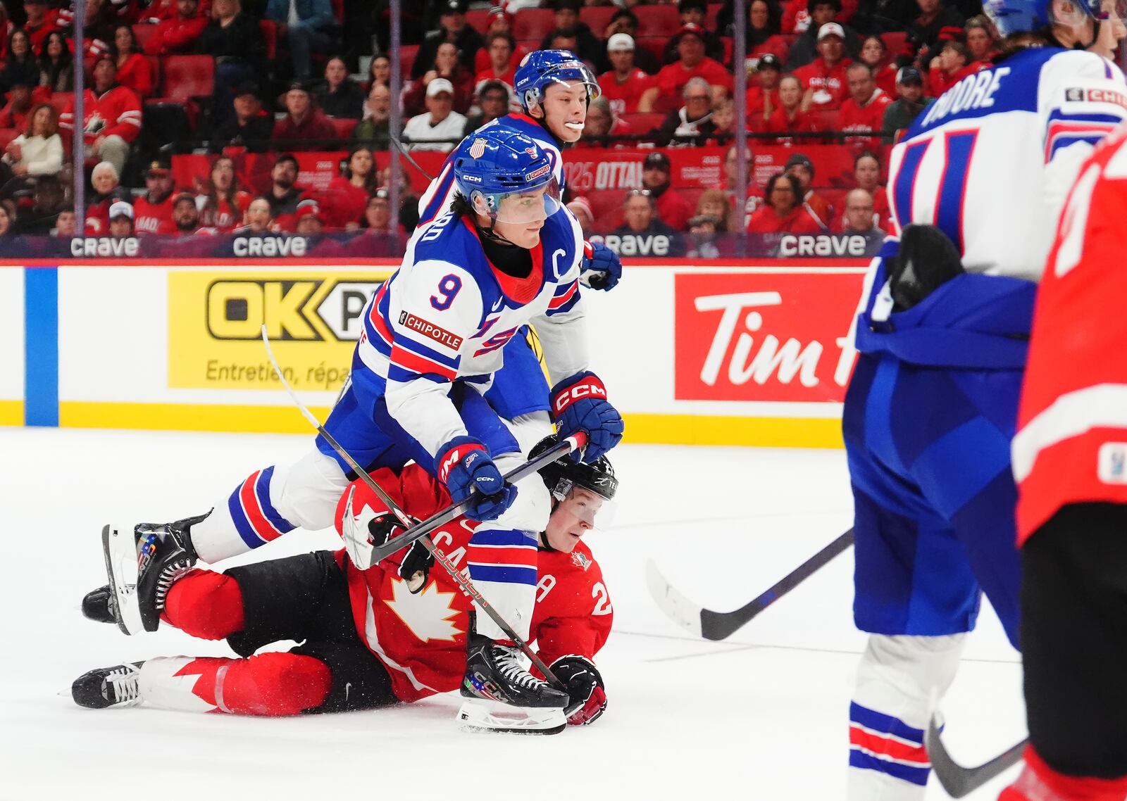 United States' Ryan Leonard (9) scores an empty-net goal over Canada's Calum Ritchie, bottom left, during third-period IIHF World Junior Hockey Championship tournament game action in Ottawa, Ontario, Tuesday, Dec. 31, 2024. (Sean Kilpatrick/The Canadian Press via AP)