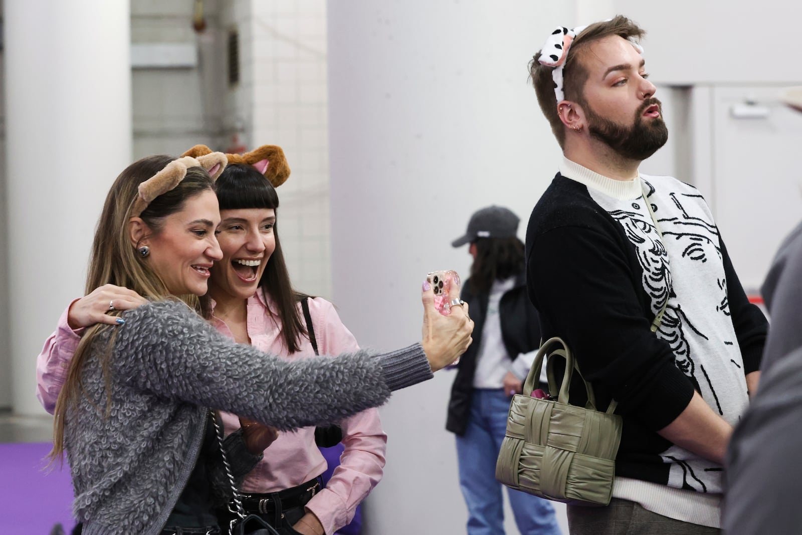 Hadley Cooper, left, and Amanda Gabriele take a selfie while watching the Masters Agility Championship Finals during the 149th Westminster Kennel Club Dog show, Saturday, Feb. 8, 2025, in New York. (AP Photo/Heather Khalifa)