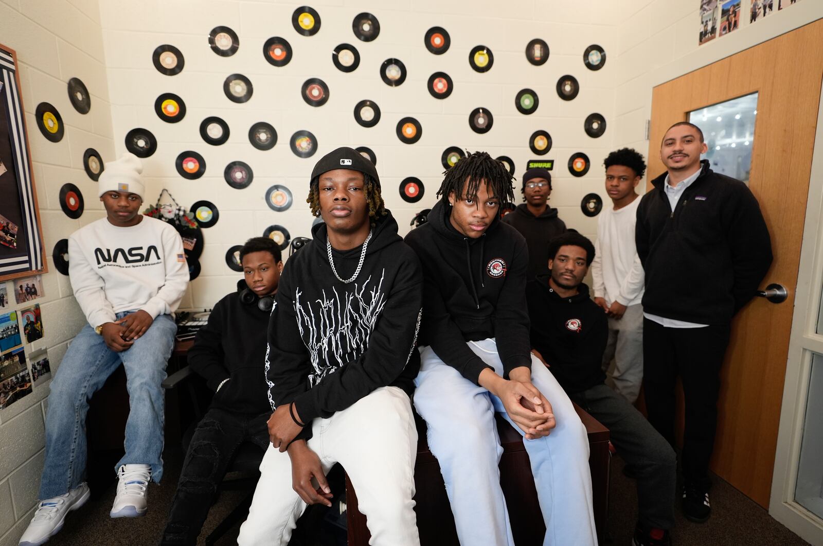 D. M. Therrell High School students and their teacher, Sam Davis, far right, gather in their podcast recording room, with funding help from Save The Music, for a photograph Monday, Jan. 27, 2025, in Atlanta. (AP Photo/Brynn Anderson)