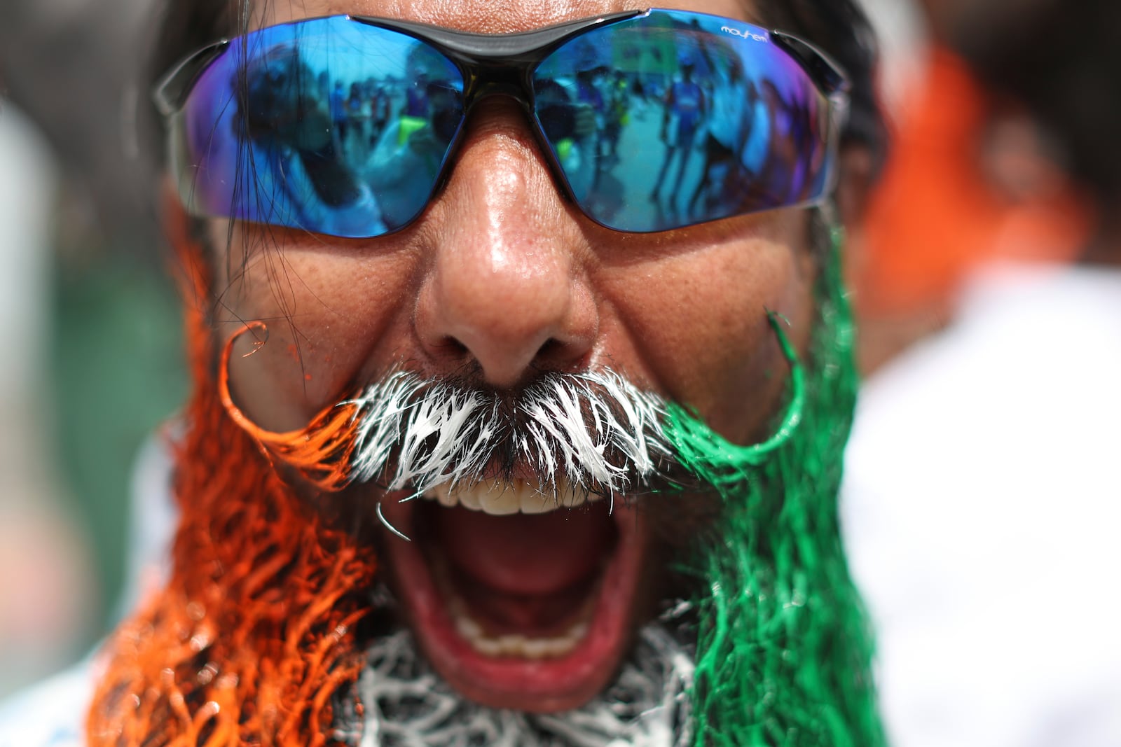 An Indian fan cheers as he arrives to watch the ICC Champions Trophy final cricket match between India and New Zealand at Dubai International Cricket Stadium in Dubai, United Arab Emirates, Sunday, March 9, 2025. (AP Photo/Christopher Pike)