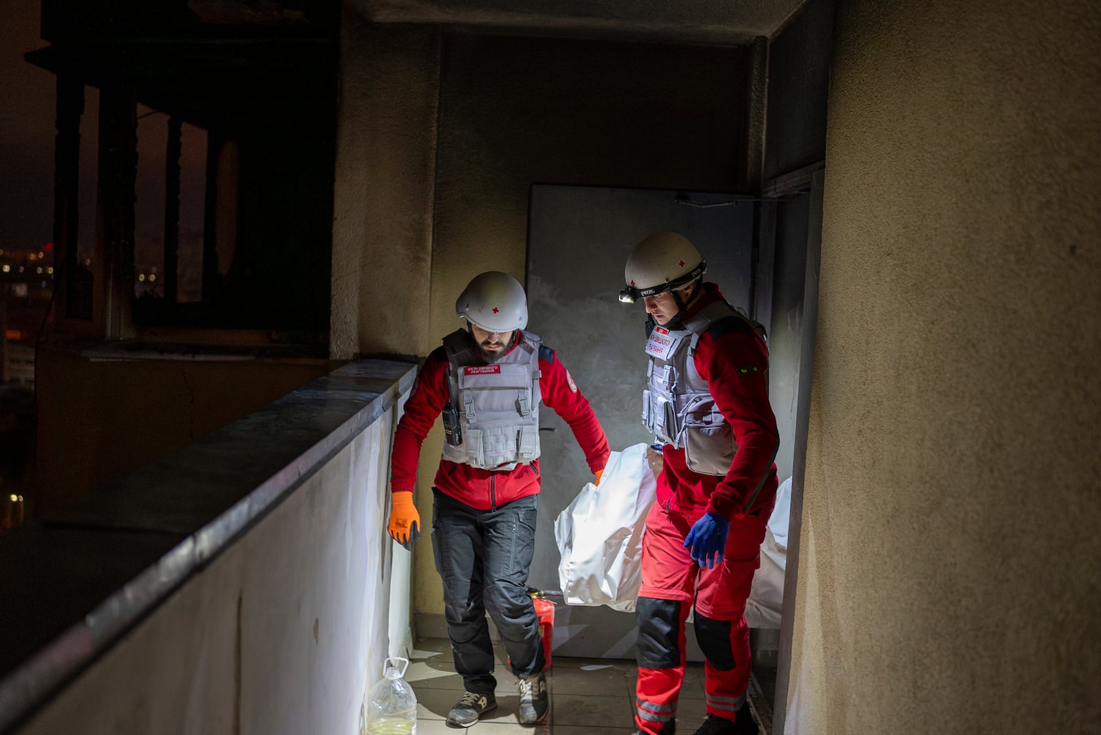 A medical emergency team carry the body of a teenager who died after a Russian attack in Kyiv, Ukraine, early Saturday, Oct. 26, 2024. (AP Photo/Alex Babenko)