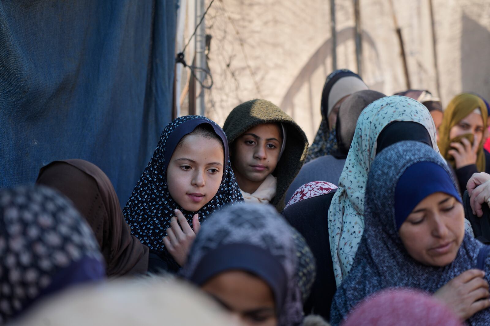 Palestinians queue for food distribution in Deir al-Balah, Gaza Strip, Friday, Feb. 14, 2025. (AP Photo/Abdel Kareem Hana)