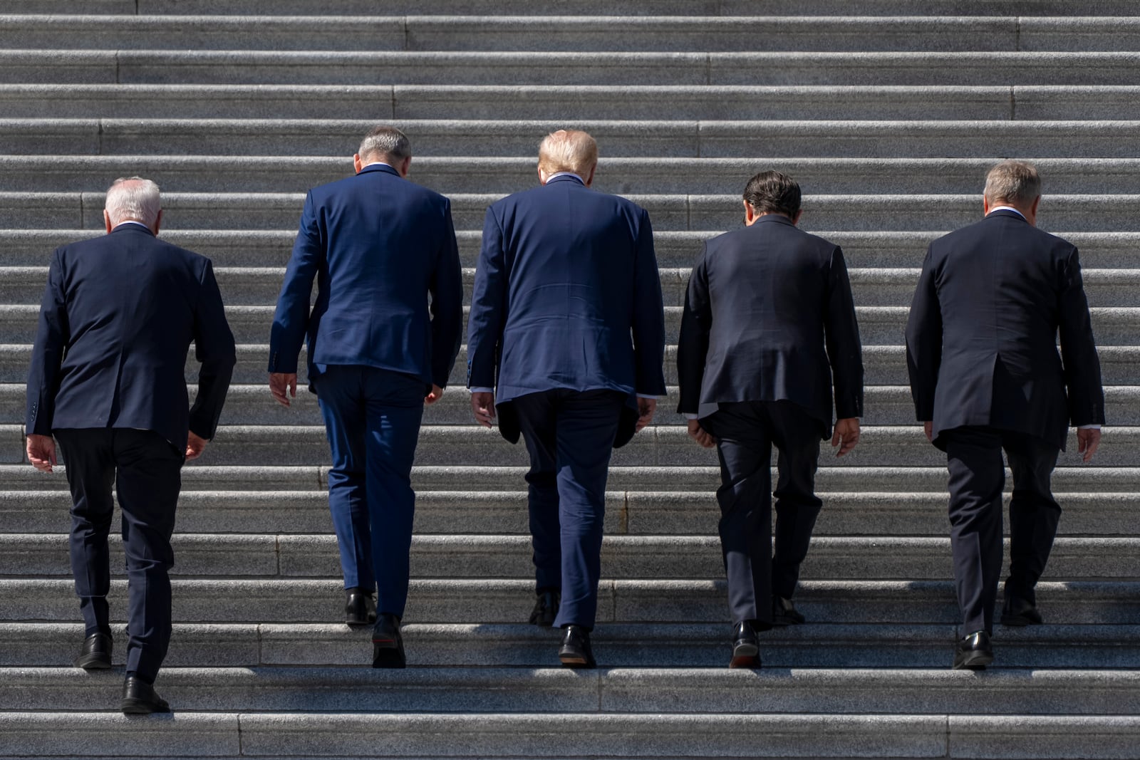 Ireland's Prime Minister Micheal Martin, second from left, President Donald Trump, center, and Speaker of the House Mike Johnson, R-La., second from right, flanked by members of Congress, walk up the stairs on the East Front House Steps of the Capitol, Wednesday, March 12, 2025, in Washington. (AP Photo/Jacquelyn Martin)