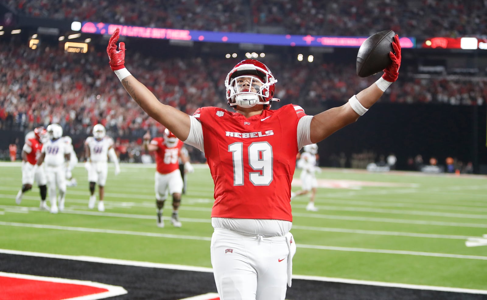 UNLV tight end Kaleo Ballungay (19) celebrates after a touchdown reception against Boise State during the first half of an NCAA college football game at Allegiant Stadium, Friday, Oct. 25, 2024, in Las Vegas. (Steve Marcus/Las Vegas Sun via AP)