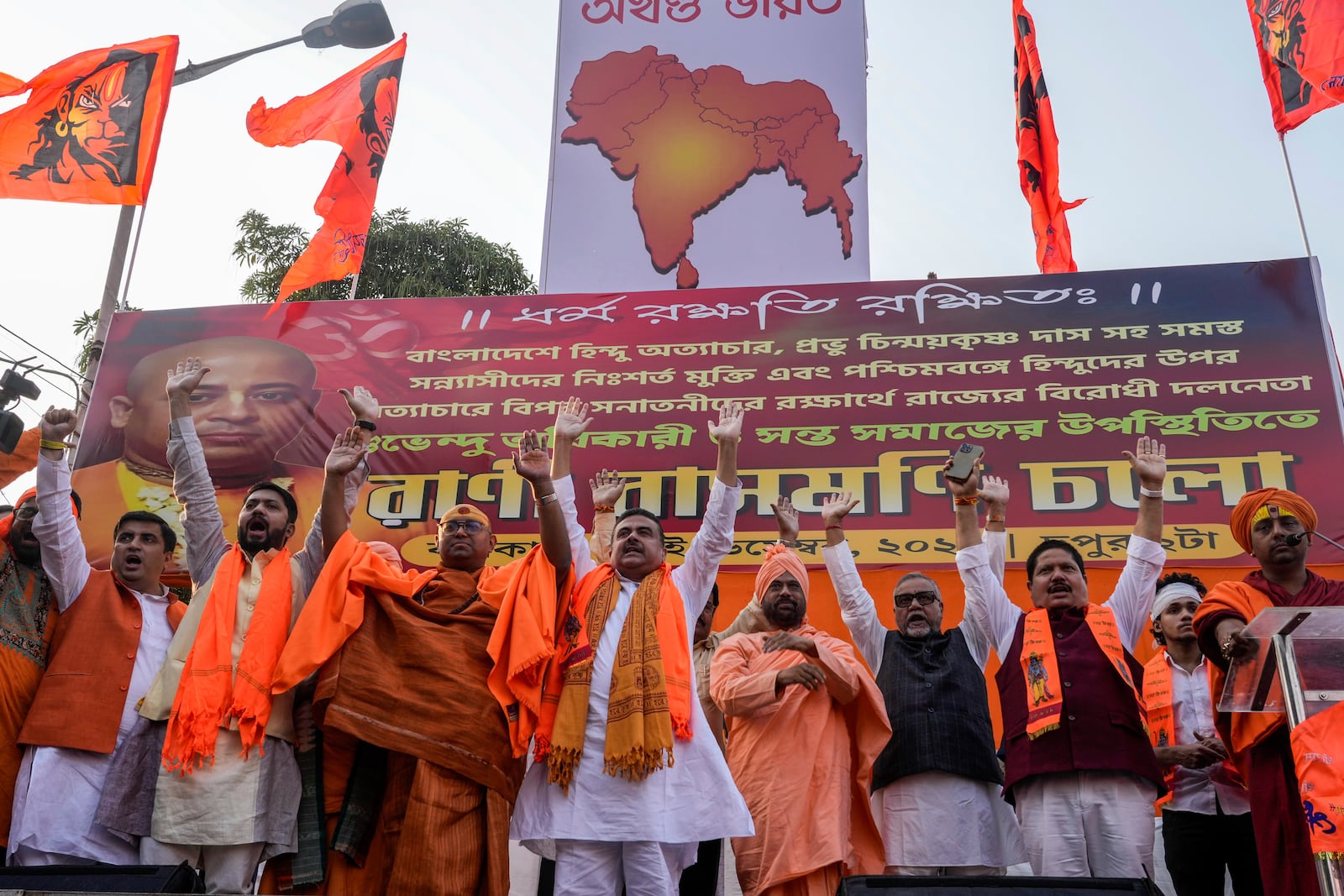 Suvendu Adhikari, fourth from left, an Indian politician from Bharatiya Janata Party joins Hindu religious leaders at a protest rally condemning the recent arrest of prominent Hindu leader Krishna Das Prabhu and the alleged attacks on Hindus in Bangladesh, in Kolkata, India, Thursday, Dec. 5, 2024. (AP Photo/Bikas Das)