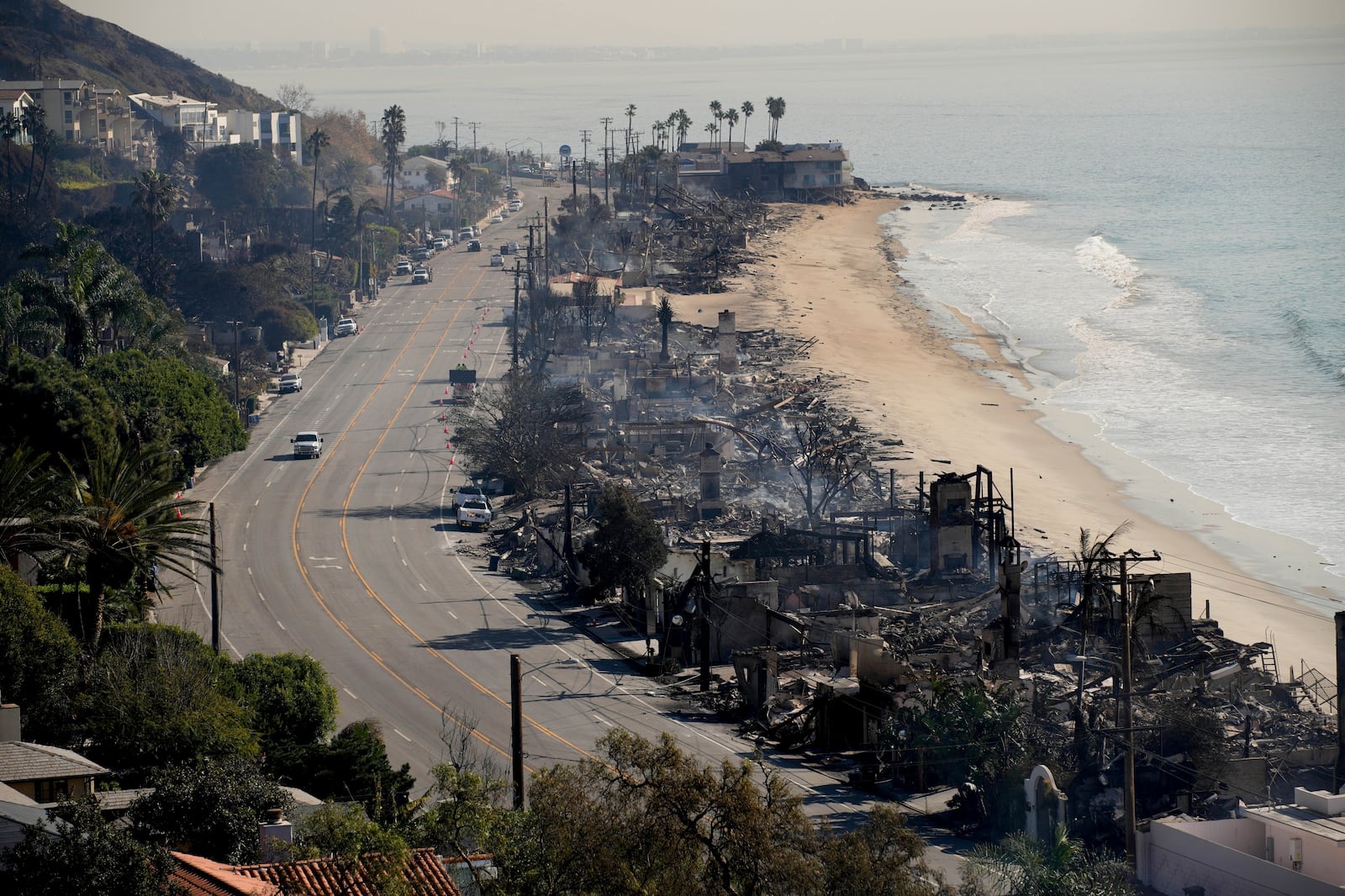 FILE - Beach front properties are left smoldering in the aftermath of the Palisades Fire Friday, Jan. 10, 2025 in Malibu, Calif. (AP Photo/John Locher, File)