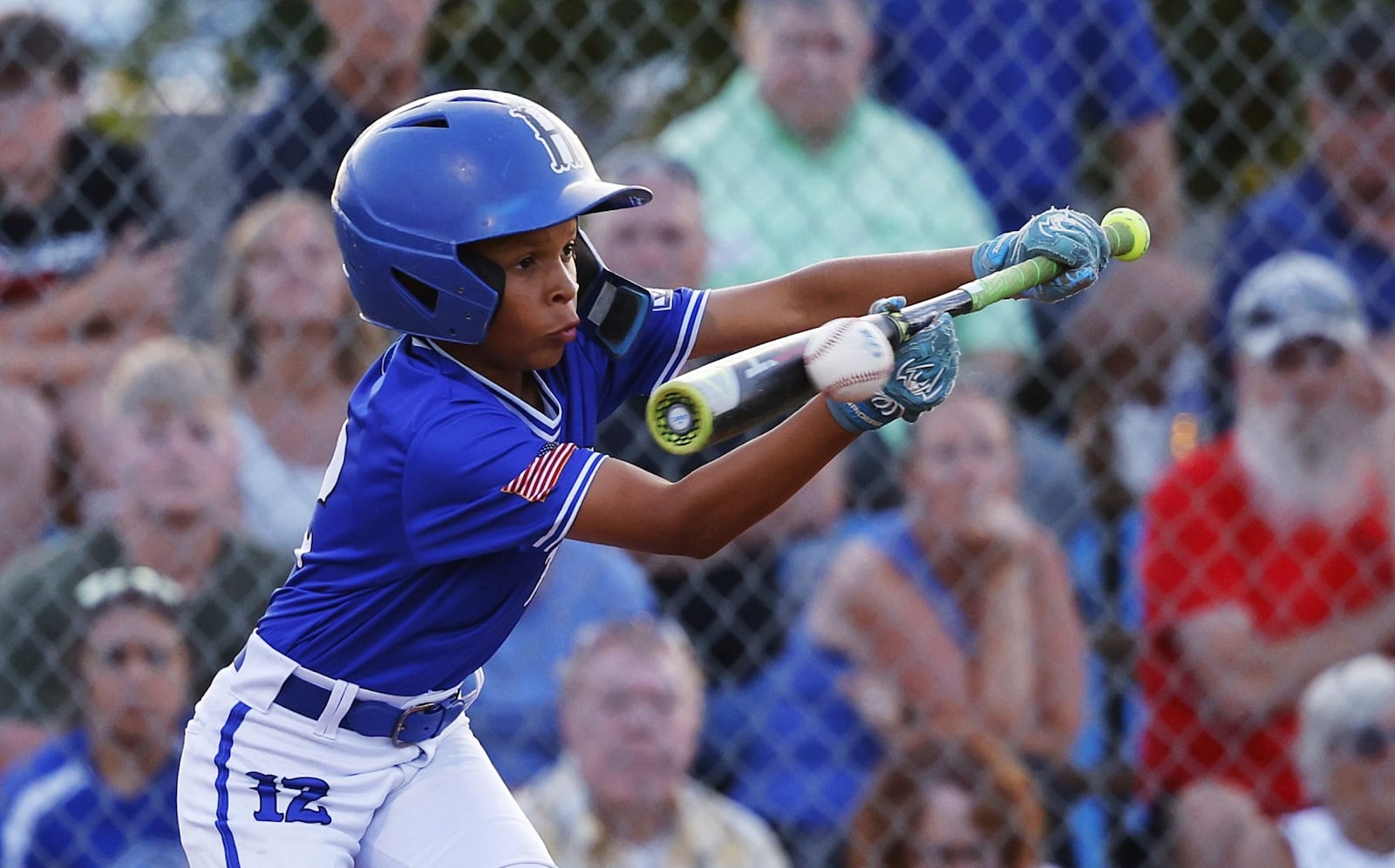 Elijah Holmes bunts the ball during Hamilton West Side's 13-2 win over New Albany to advance in the Little League state tournament Saturday, July 20, 2024 at West Side Little League field in Hamilton. NICK GRAHAM/STAFF