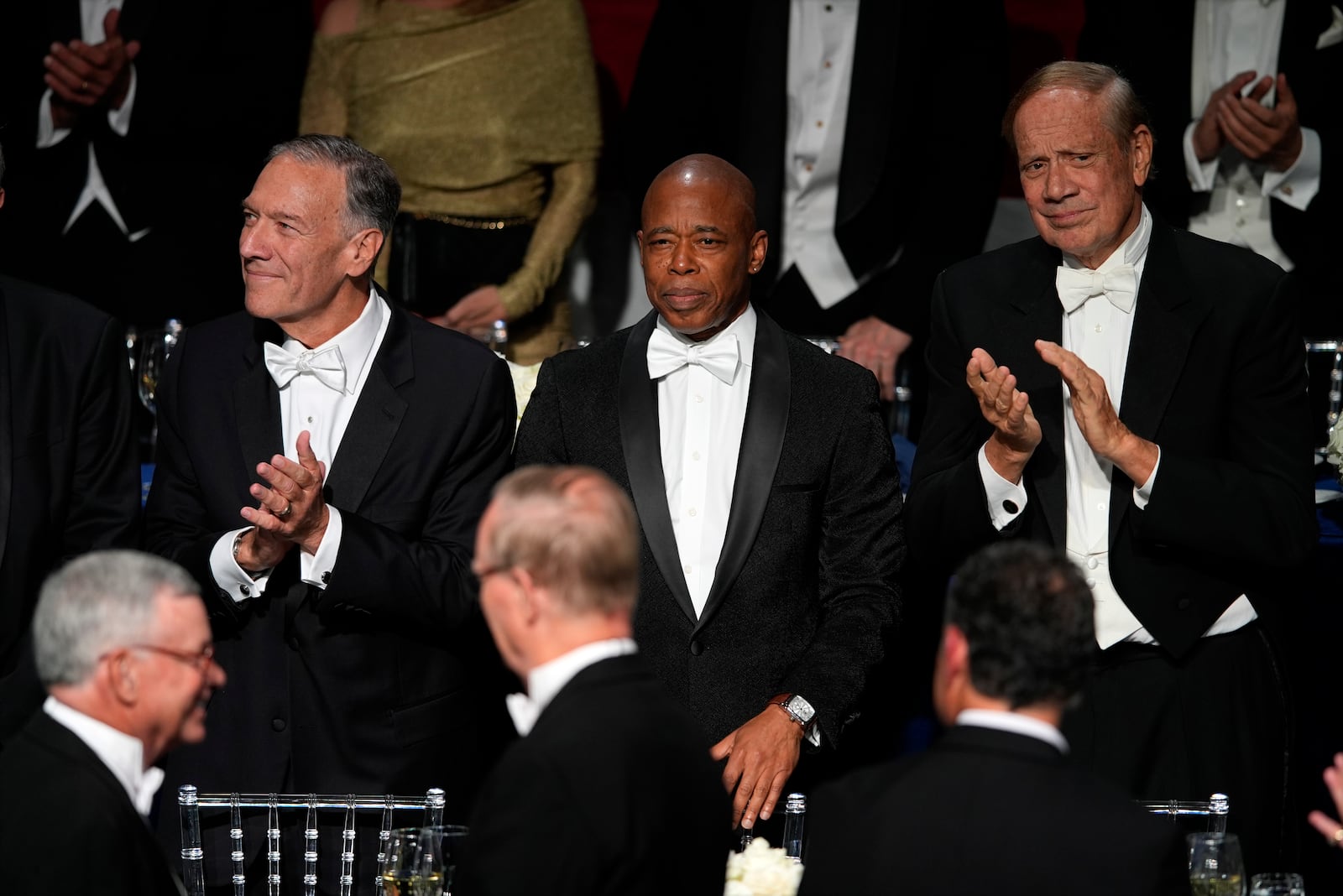 New York City Mayor Eric Adams, center, and former Secretary of State Mike Pompeo, left, arrive for the 79th annual Alfred E. Smith Memorial Foundation Dinner, Thursday, Oct. 17, 2024, in New York. (AP Photo/Julia Demaree Nikhinson)