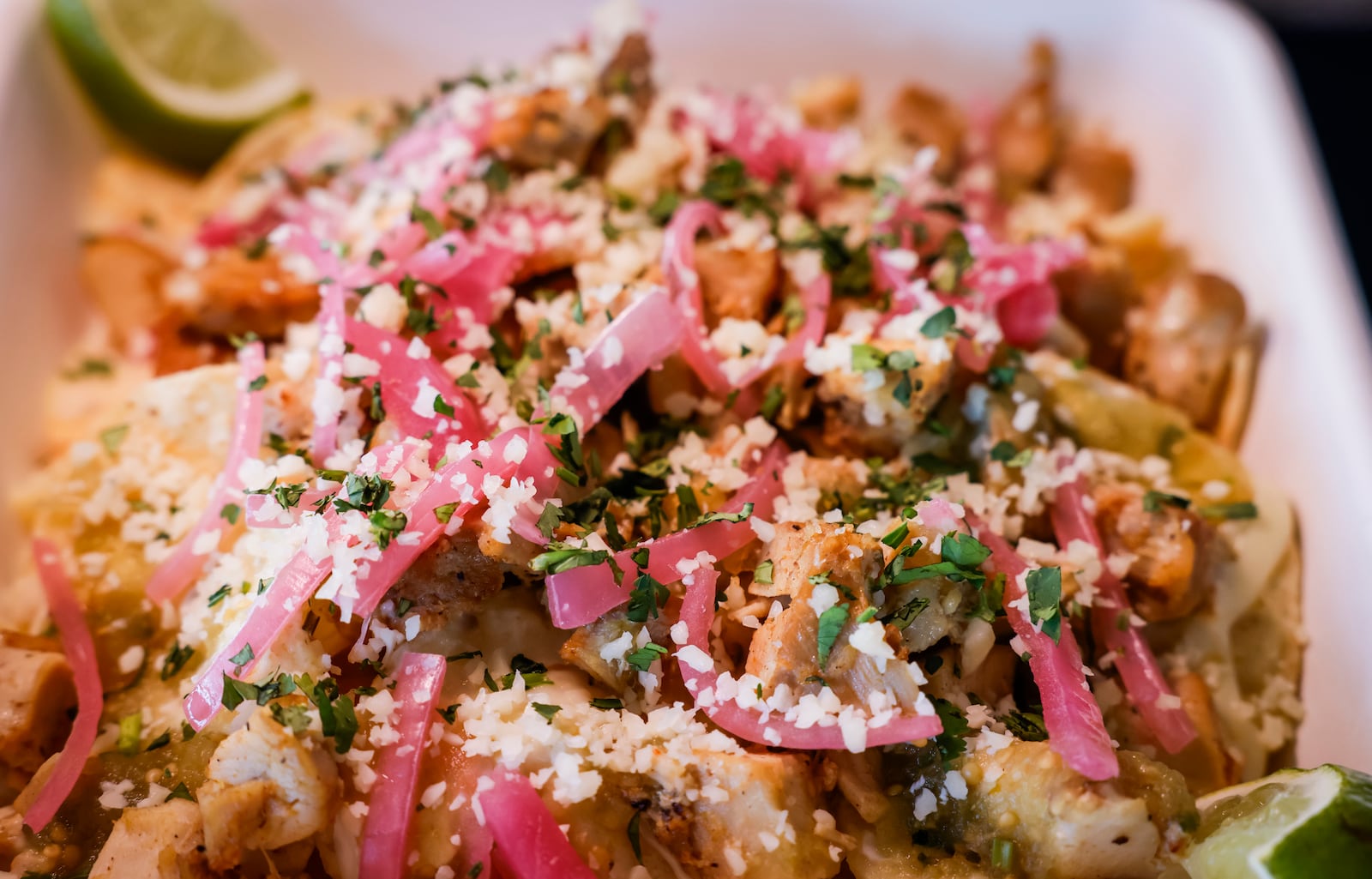 The Cincinnati Reds announced new menu items ahead of opening day on Friday, March 21, 2025 in The Handlebar at the Riverfront Club inside Great American Ball Park in Cincinnati. Executive Chef Gary Davis created a variety of new dishes for the upcoming season. This is their Street Nachos with chicken or steak, queso, pickled red onions, salsa verde and cotija cheese. NICK GRAHAM/STAFF