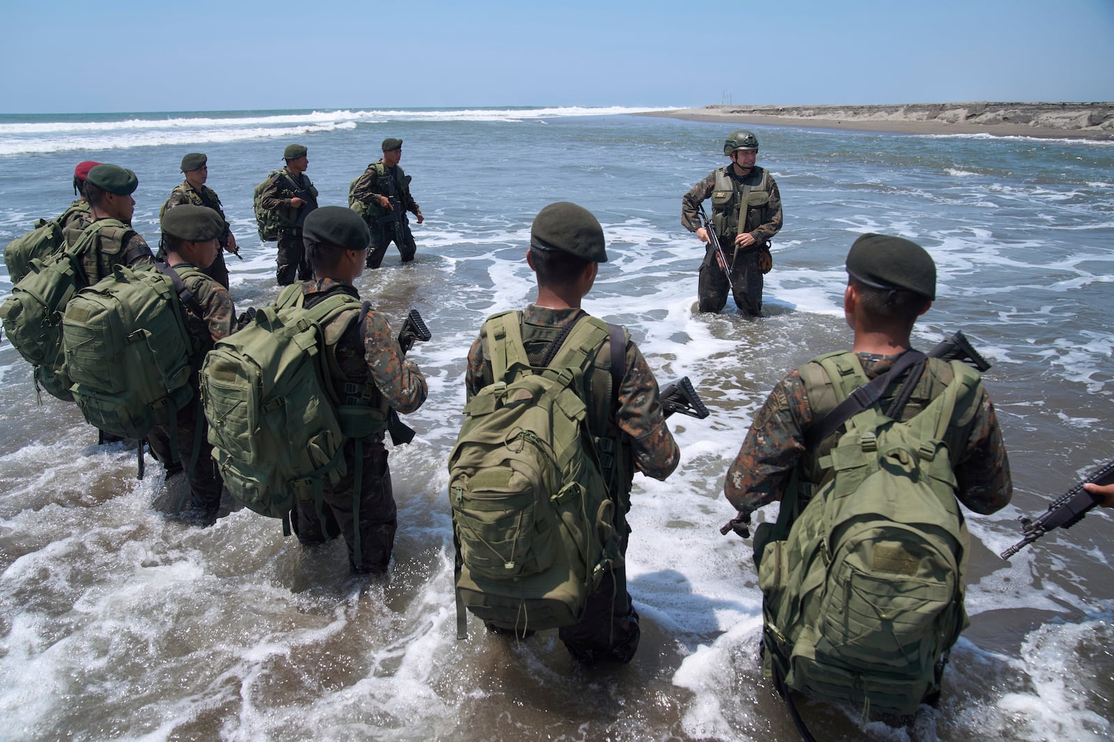 Army Colonel Juan Celis Mendizabal, top, gives instructions to soldiers as they patrol the shared border with Mexico as part of the Ring of Fire operation, aiming to strengthen border control in the Suchiate River in Ocos, Guatemala, Thursday, March 13, 2025. (AP Photo/Moises Castillo)