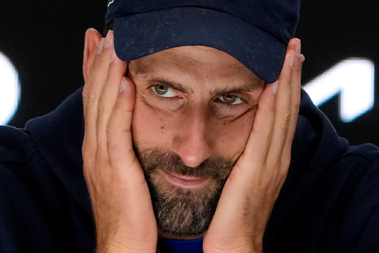 Novak Djokovic of Serbia reacts at a press conference after retiring in his semifinal match against Alexander Zverev of Germany at the Australian Open tennis championship in Melbourne, Australia, Friday, Jan. 24, 2025. (AP Photo/Asanka Brendon Ratnayake)