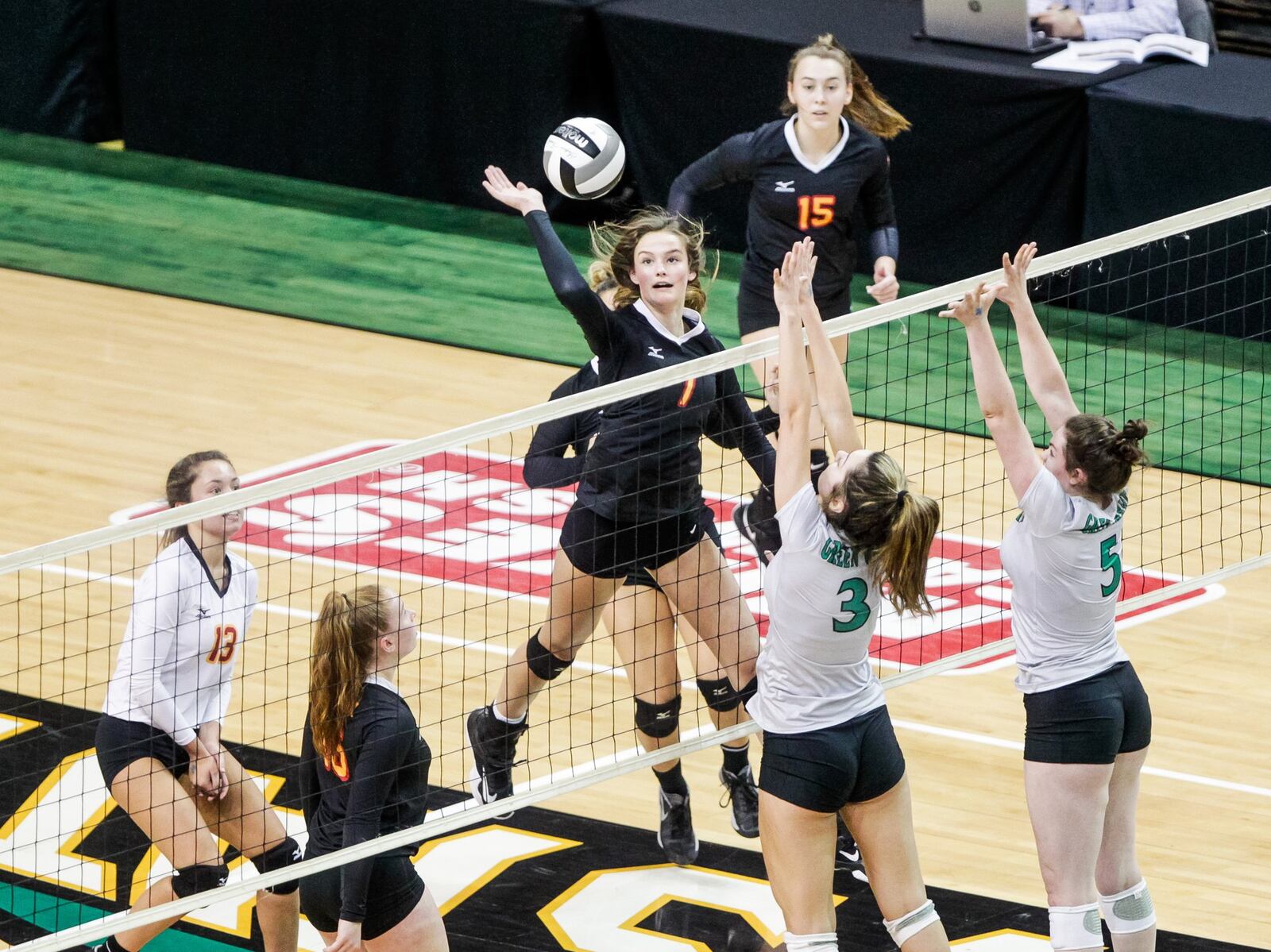 Fenwick’s Elizabeth Hoerlein hits the ball over the net as Parma Heights Holy Name’s Samantha Snow (3) and Ava Nice (5) defend during Friday’s Division II state volleyball semifinal at Wright State University’s Nutter Center. NICK GRAHAM/STAFF