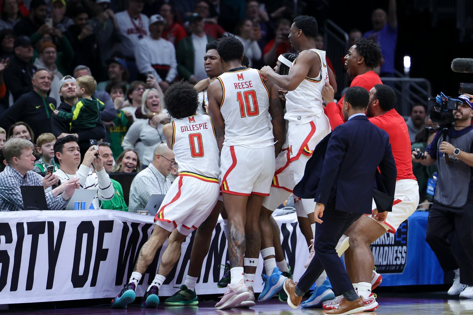 Maryland center Derik Queen, center, reacts with teammates after making the game-winning shot against Colorado State during the second half in the second round of the NCAA college basketball tournament, Sunday, March 23, 2025, in Seattle. (AP Photo/Ryan Sun)