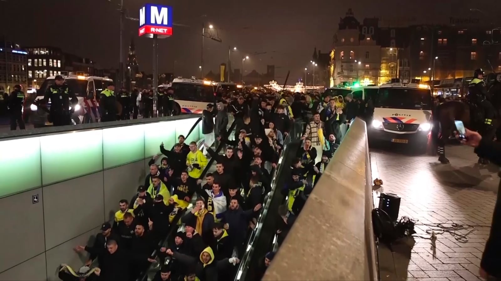 In this image taken from video, police escort Maccabi Tel Aviv supporters to the metro, after pro-Palestinian supporters marched near the soccer stadium, in Amsterdam, the Netherlands, Thursday, Nov. 7, 2024. (AP Photo InterVision)