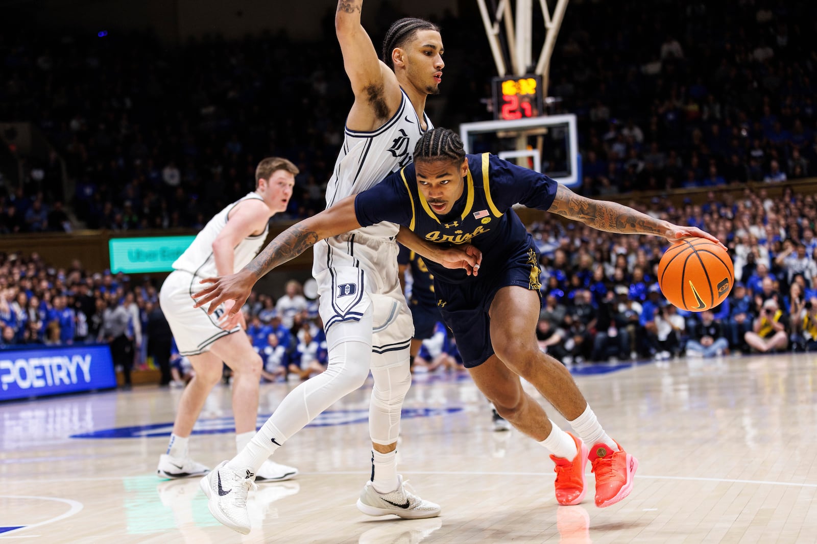 Notre Dame's Tae Davis (10) drives against Duke's Tyrese Proctor, left, during the first half of an NCAA college basketball game in Durham, N.C., Saturday, Jan. 11, 2025. (AP Photo/Ben McKeown)