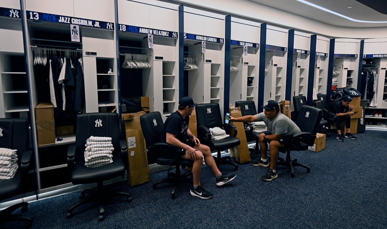 New York Yankees clubhouse attendants wait near the players' lockers during a tour of the upgraded team spring training facilities Thursday, Feb. 13, 2025, at George M. Steinbrenner Field in Tampa, Fla. (AP Photo/Steve Nesius)