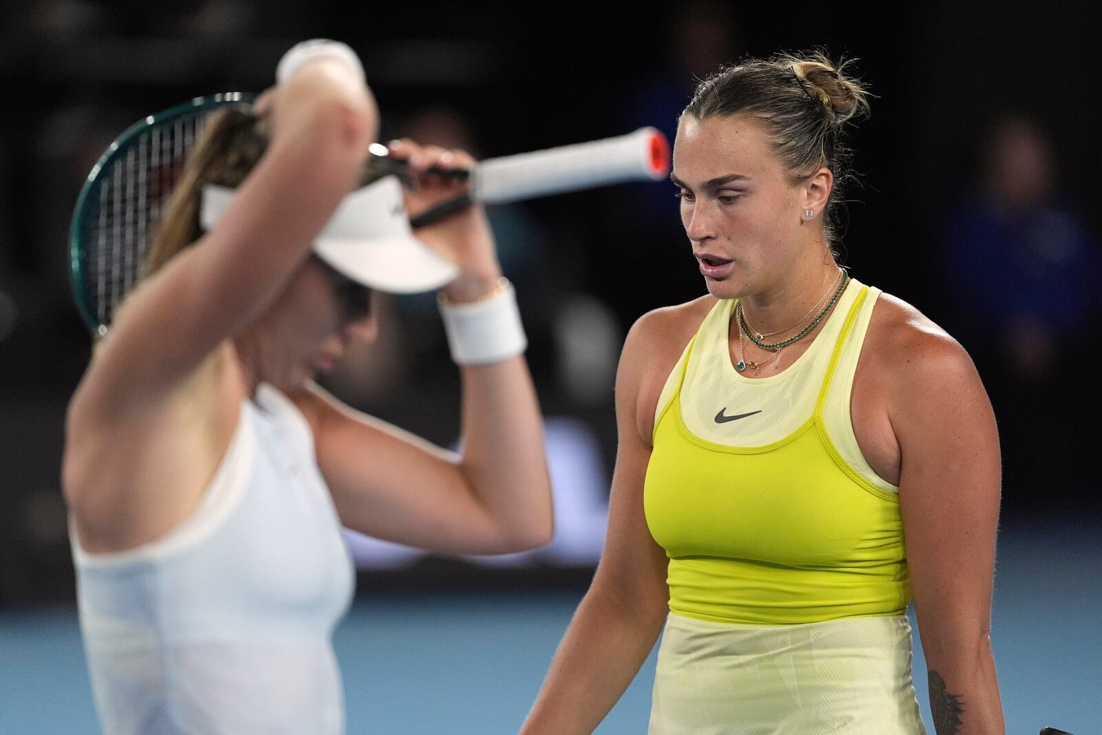 Aryna Sabalenka of Belarus walks past Paula Badosa of Spain during their semifinal match at the Australian Open tennis championship in Melbourne, Australia, Thursday, Jan. 23, 2025. (AP Photo/Ng Han Guan)