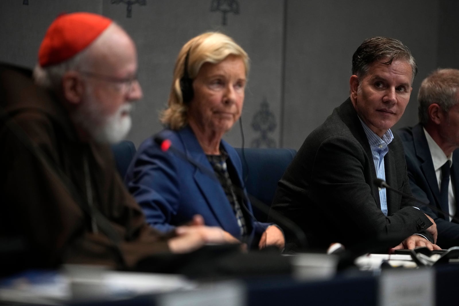 Clergy sex abuse survivor and victim's advocate Juan Carlos Cruz, right, listens to Cardinal Sean Patrick O' Malley speaking during a press conference to present the Vatican's first Annual Global Report on Minors Protection at the Vatican press center, Tuesday, Oct. 29, 2024. (AP Photo/Alessandra Tarantino)