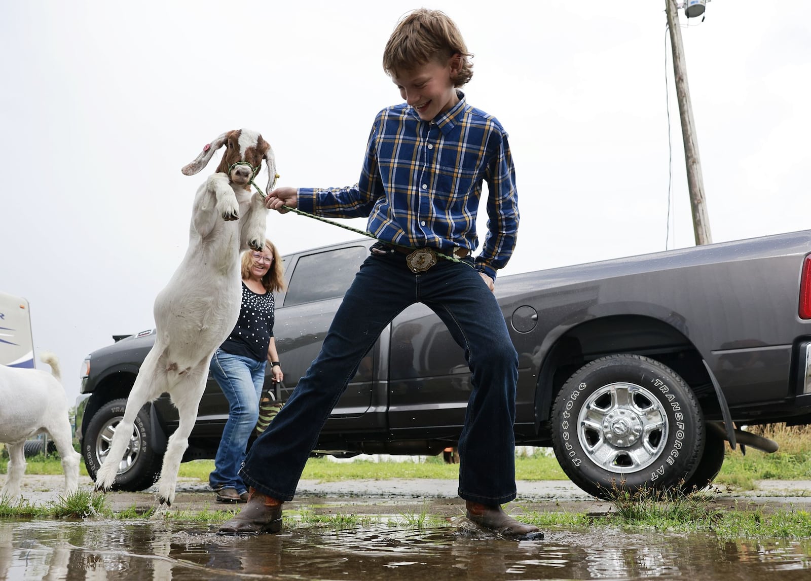 Zack Krazl, 12, walks his goat, Sandy, at his house Tuesday, July 18, 2023 in Wayne Township. Krazl will be showing his goats at the Butler County Fair. NICK GRAHAM/STAFF