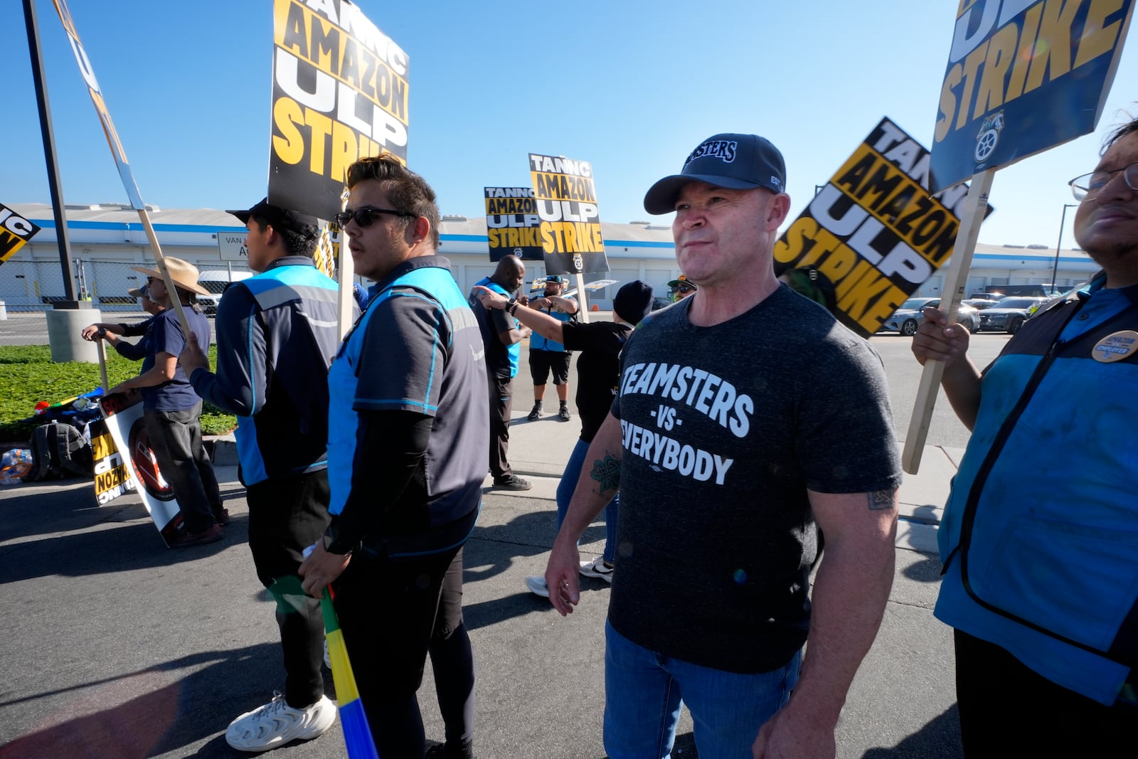 Sean O'Brien, General president of the International Brotherhood of Teamsters joins other Amazon workers during a strike outside the gates of an Amazon Fulfillment Center Friday, Dec. 20, 2024, in City of Industry, Calif. (AP Photo/Damian Dovarganes)