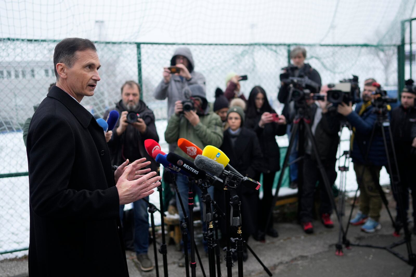 Presidential candidate Dragan Primorac talks to media during a runoff vote for the Croatian presidential election at a polling station in Zagreb, Croatia, Sunday, Jan. 12, 2025. (AP Photo/Darko Bandic)