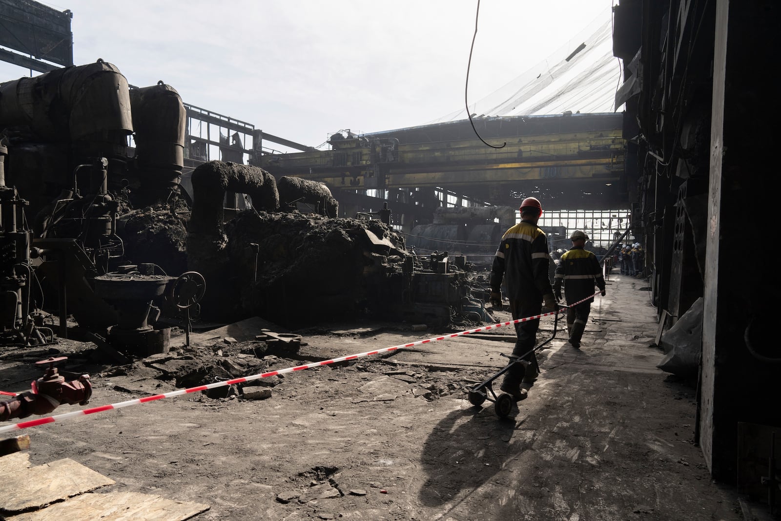 FILE - Workers walk inside DTEK's power plant which was destroyed by a Russian missile attack in Ukraine, April 2, 2024. (AP Photo/Evgeniy Maloletka, File)