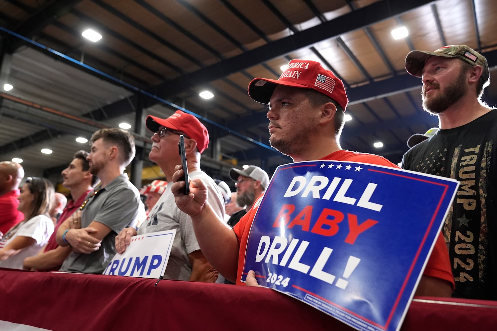 FILE - Attendees listen as Republican presidential nominee former President Donald Trump speaks during a campaign event at Alro Steel, Aug. 29, 2024, in Potterville, Mich. (AP Photo/Alex Brandon, File)